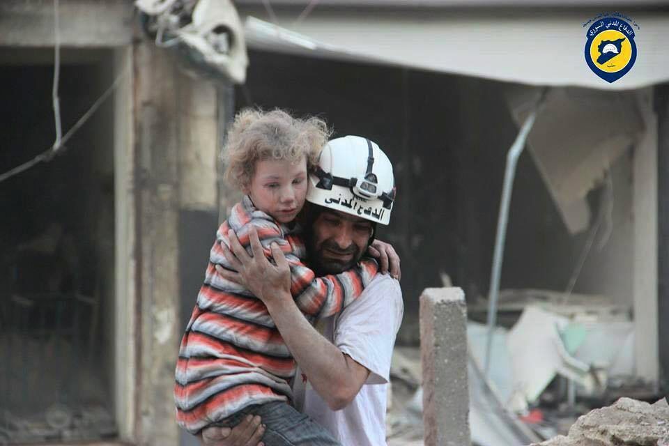 epa05574316 An undated handout picture made available by the Syria Civil Defence volunteer organization on 07 October 2016 showing a volunteer carrying a child victim in Aleppo, Syria. Syria Civil Defence is a volunteer group, also known as the White Helmets, that consists of over three thousand local volunteers spread across areas of conflict around Syria. In the past three years they saved over 62 thousand Syrian lives, while losing 145 volunteer during airstrikes and 430 others injured.  EPA/SYRIA CIVIL DEFENCE / HANDOUT  HANDOUT EDITORIAL USE ONLY/NO SALES SYRIA WHITE HELMETS