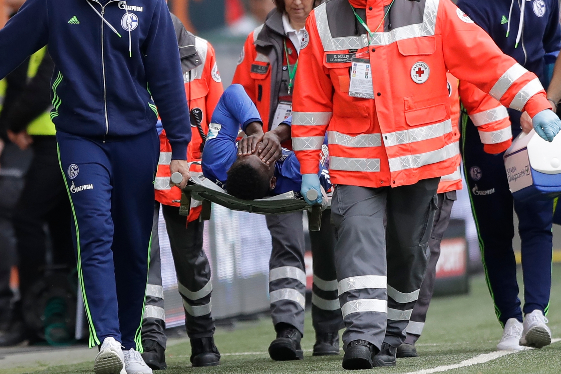 Schalke's Breel Embolo leaves the field on a stretcher during the German Bundesliga soccer match between FC Augsburg and FC Schalke 04 in Augsburg, Germany, Saturday, Oct. 15, 2016. (AP Photo/Matthias Schrader) Germany Soccer Bundesliga