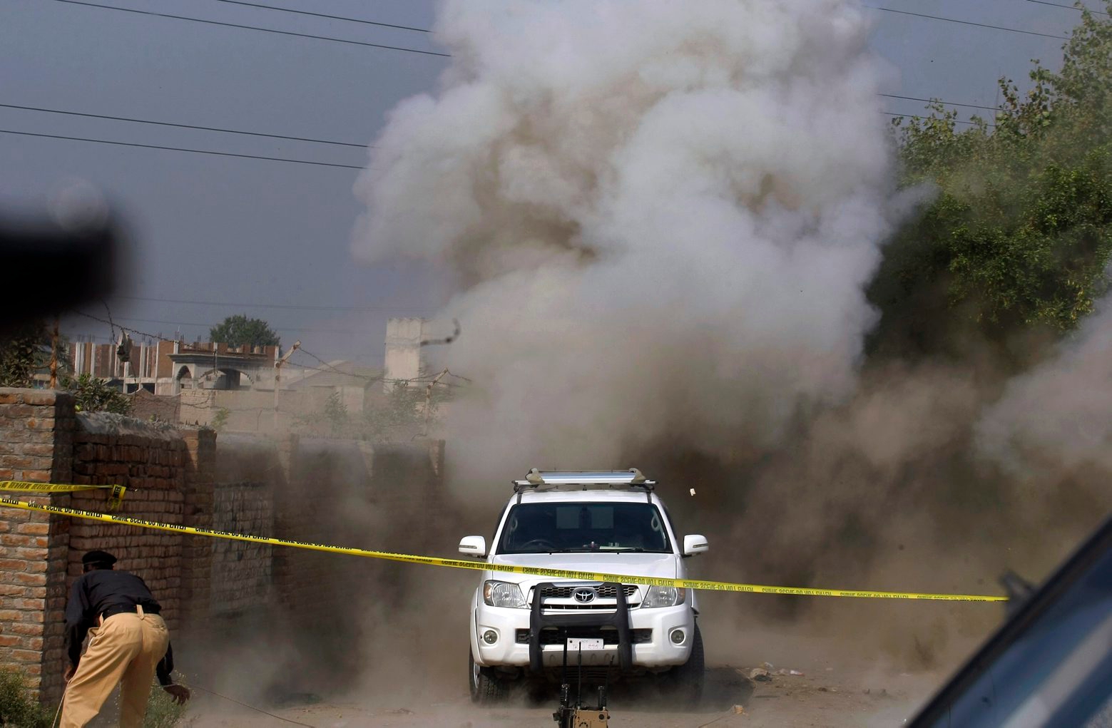 Dust and smoke rises after a bomb is detonated in by a bomb disposal squad on the outskirts of Peshawar, Pakistan, Tuesday, Oct. 25, 2016. Earlier a roadside bomb targeted a police patrol on guard for a polio vaccination team on the outskirts of Peshawar, killing one policeman, according to Superintendent of Police Furqan Bilal, who himself narrowly escaped. He said there were more improvised explosives devices buried in the area. (AP Photo/Muhammad Sajjad) Pakistan