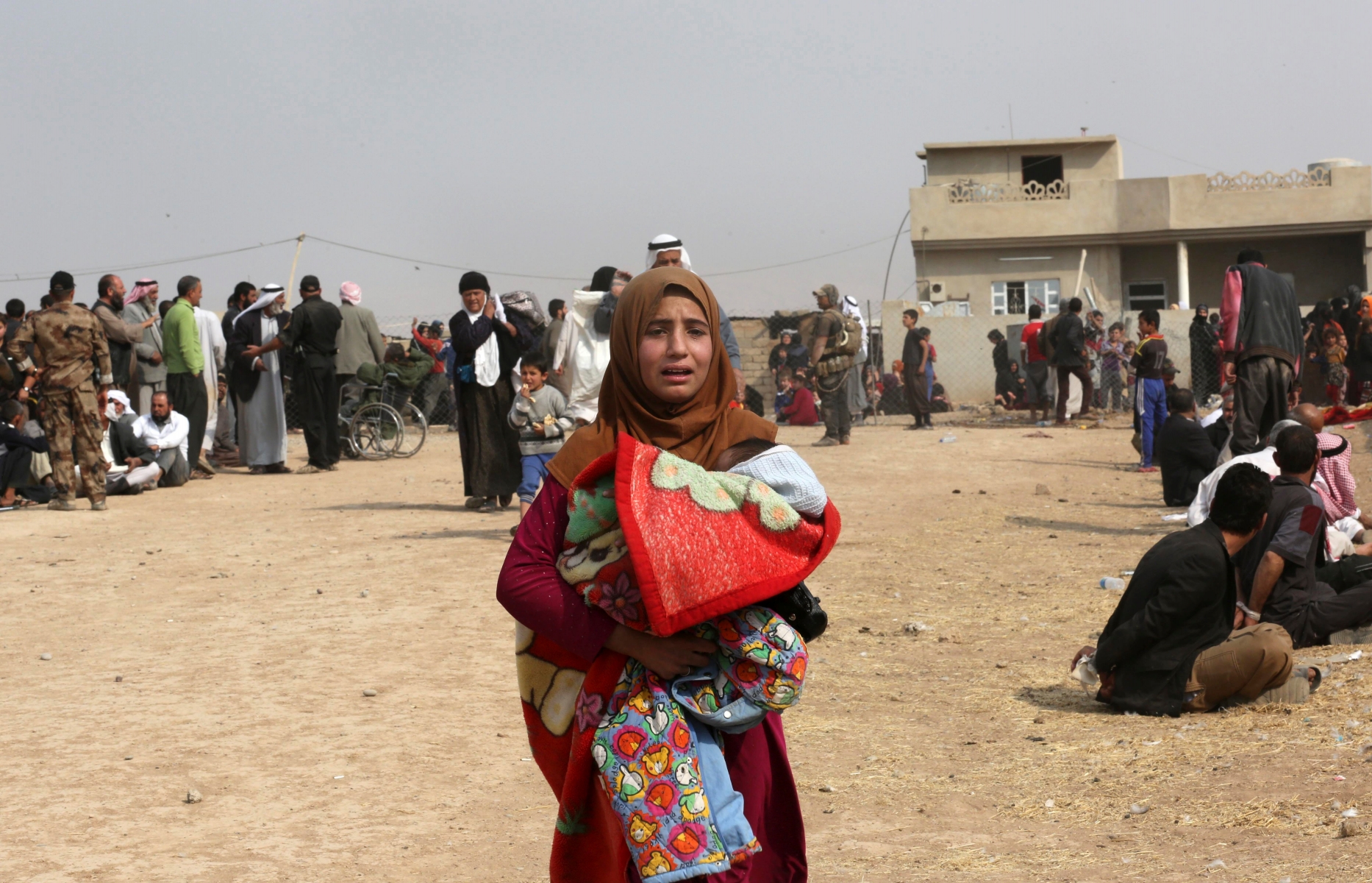 A woman cries as civilians leave their homes as Iraq's elite counterterrorism forces fight Islamic State militia in the village of Tob Zawa, about 9 kilometers (5½ miles) from Mosul, Iraq, Tuesday, Oct. 25, 2016. (AP Photo/Khalid Mohammed) Mideast Iraq