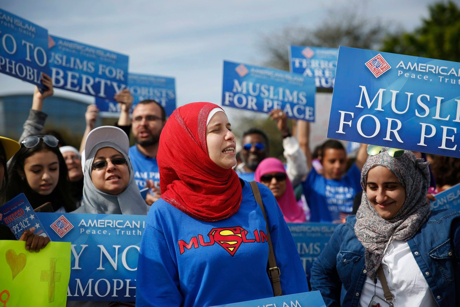 Protesters stand across the street from a Donald Trump rally holding signs for "Muslims for Peace," signs before a campaign rally, Saturday, March 5, 2016, in Orlando, Fla. (AP Photo/Brynn Anderson) GOP 2016 Trump