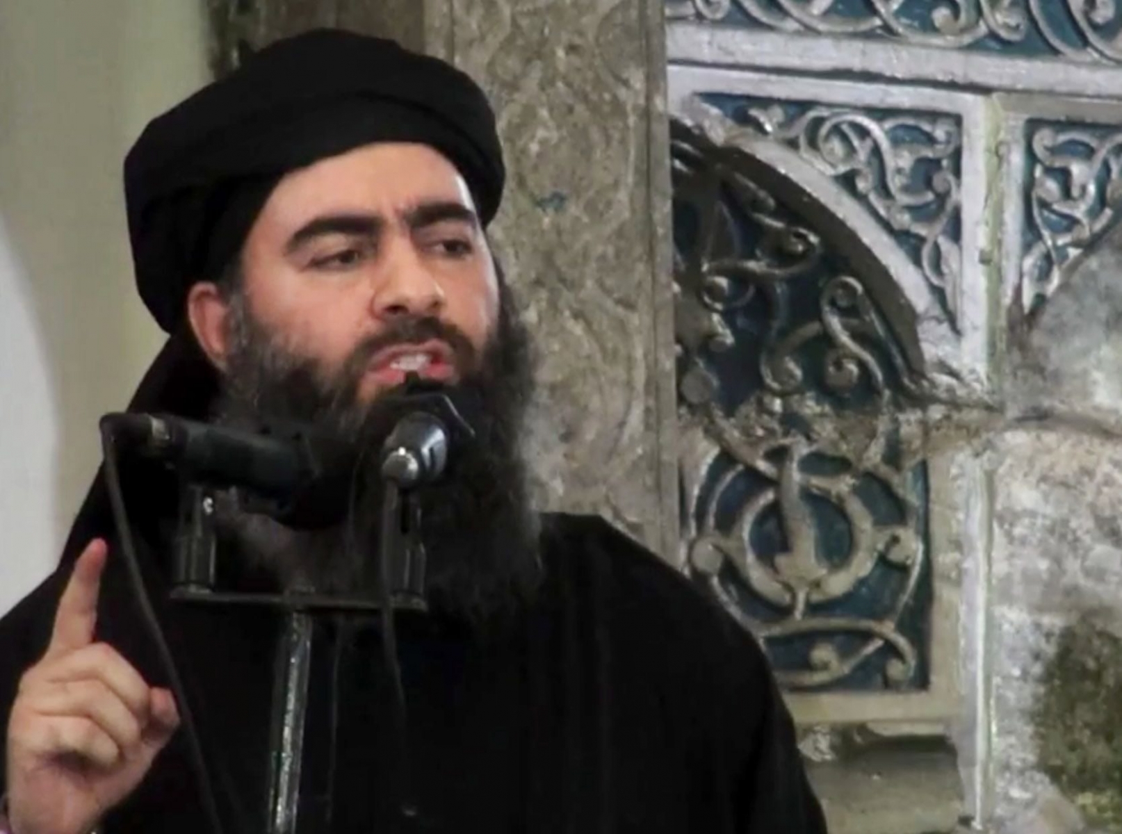 FILE - This file image made from video posted on a militant website Saturday, July 5, 2014, purports to show the leader of the Islamic State group, Abu Bakr al-Baghdadi, delivering a sermon at a mosque in Iraq during his first public appearance. The Islamic State group has released a new message purportedly from its reclusive leader, claiming his self-styled ìcaliphateî is doing ìwellî despite an unprecedented alliance against it. (AP Photo/Militant video, File) MIDEAST ISLAMIC STATE