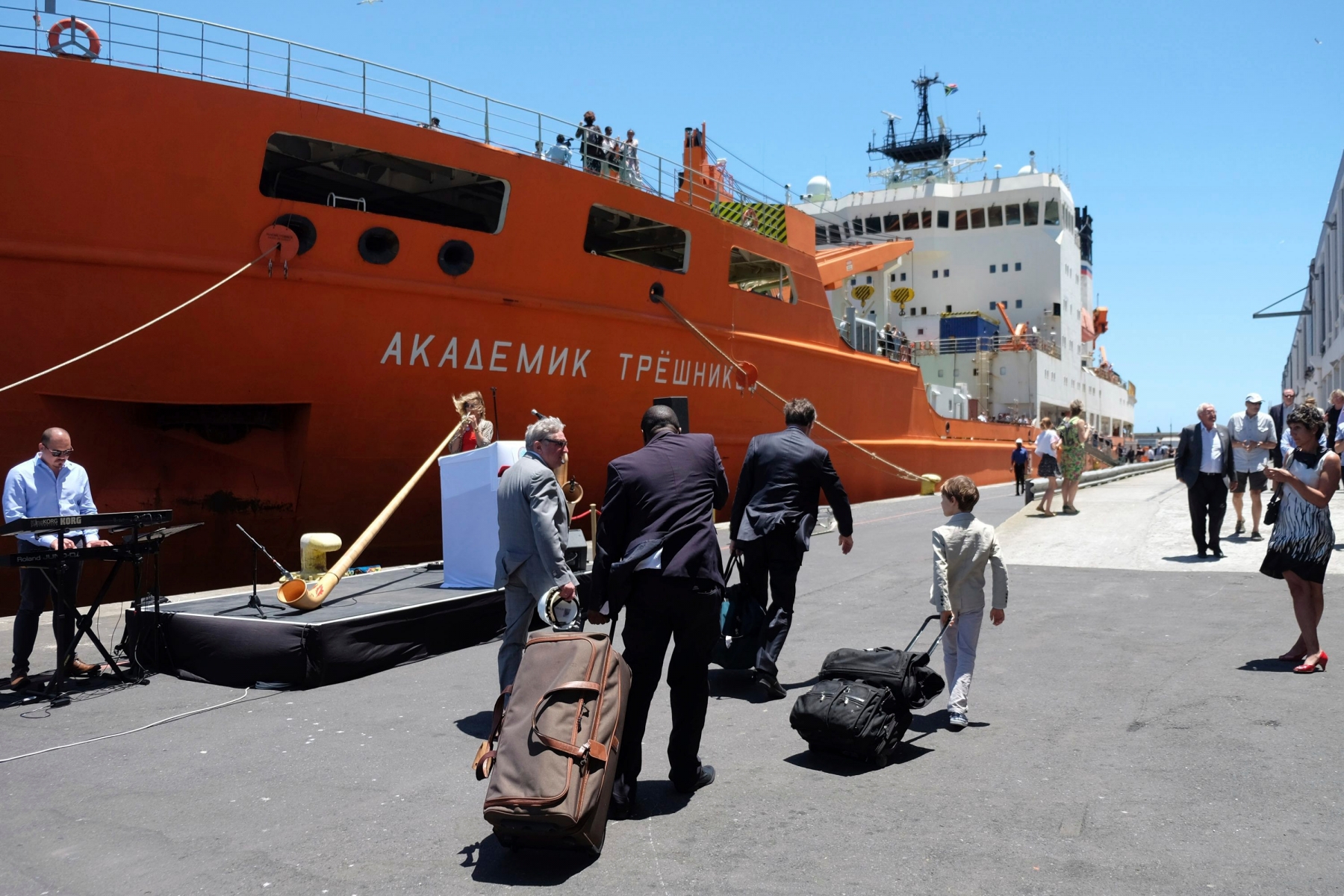 Team members arrive with luggage to board the Akademik Treshnikov, a Russian research vessel, in Cape Town, South Africa, Tuesday, Dec. 20, 2016 prior it's departure for the Antactic. It's aim is to study the earth's poles and extreme environments and to explore crucial issues that the scientific and political communities face in the area of climate change. The vessel will carry 55 researchers from 18 countries. (AP Photo/Dean Hutton) South Africa Antarctica Circumnavigation Expedition