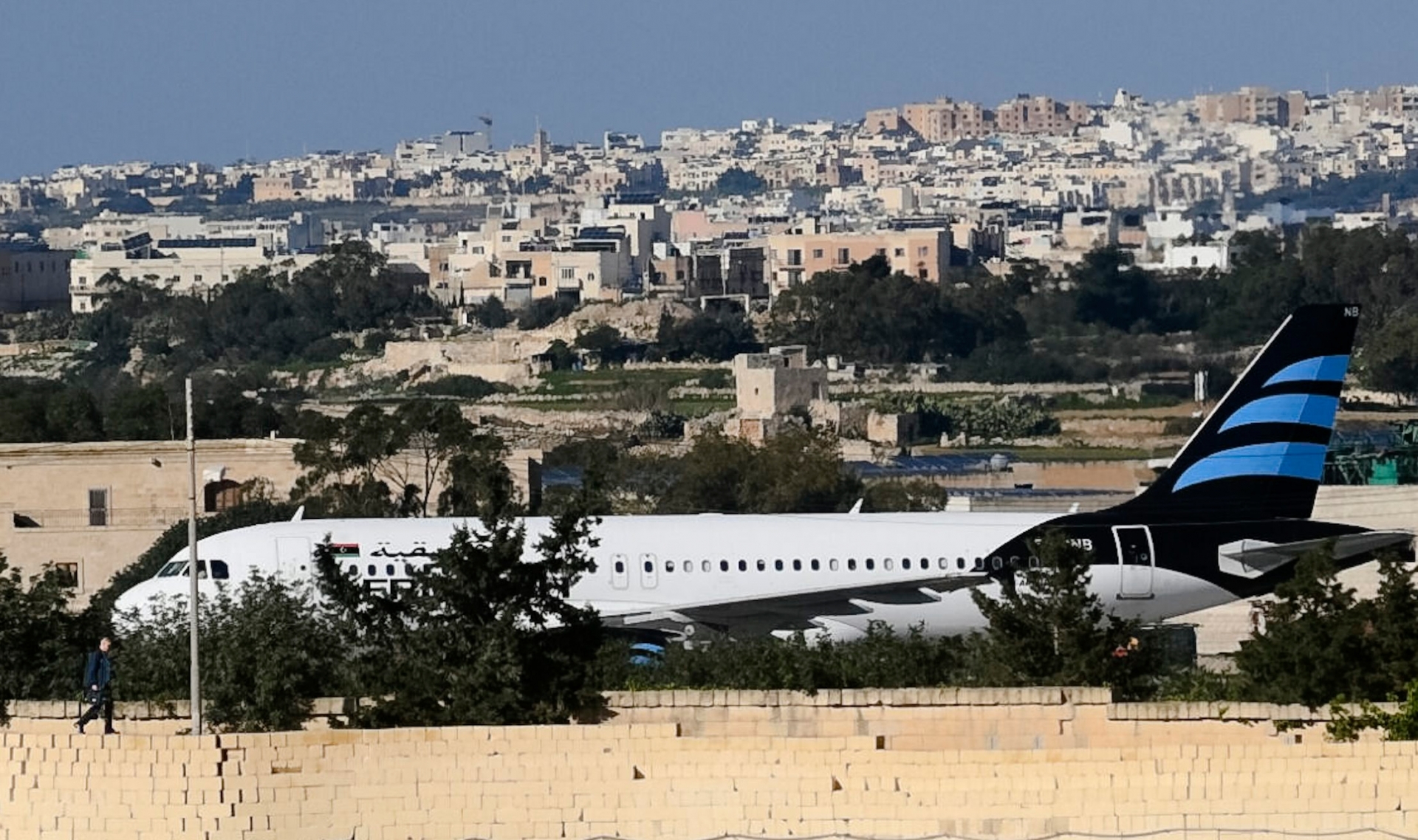 An Afriqiyah Airways plane from Libya stands on the tarmac at Malta's Luqa International airport, Friday, Dec. 23, 2016. Two hijackers diverted a Libyan commercial plane to Malta on Friday and threatened to blow it up with hand grenades, Maltese authorities and state media said.  (AP Photo/Jonathan Borg) Malta Libya Hijacking