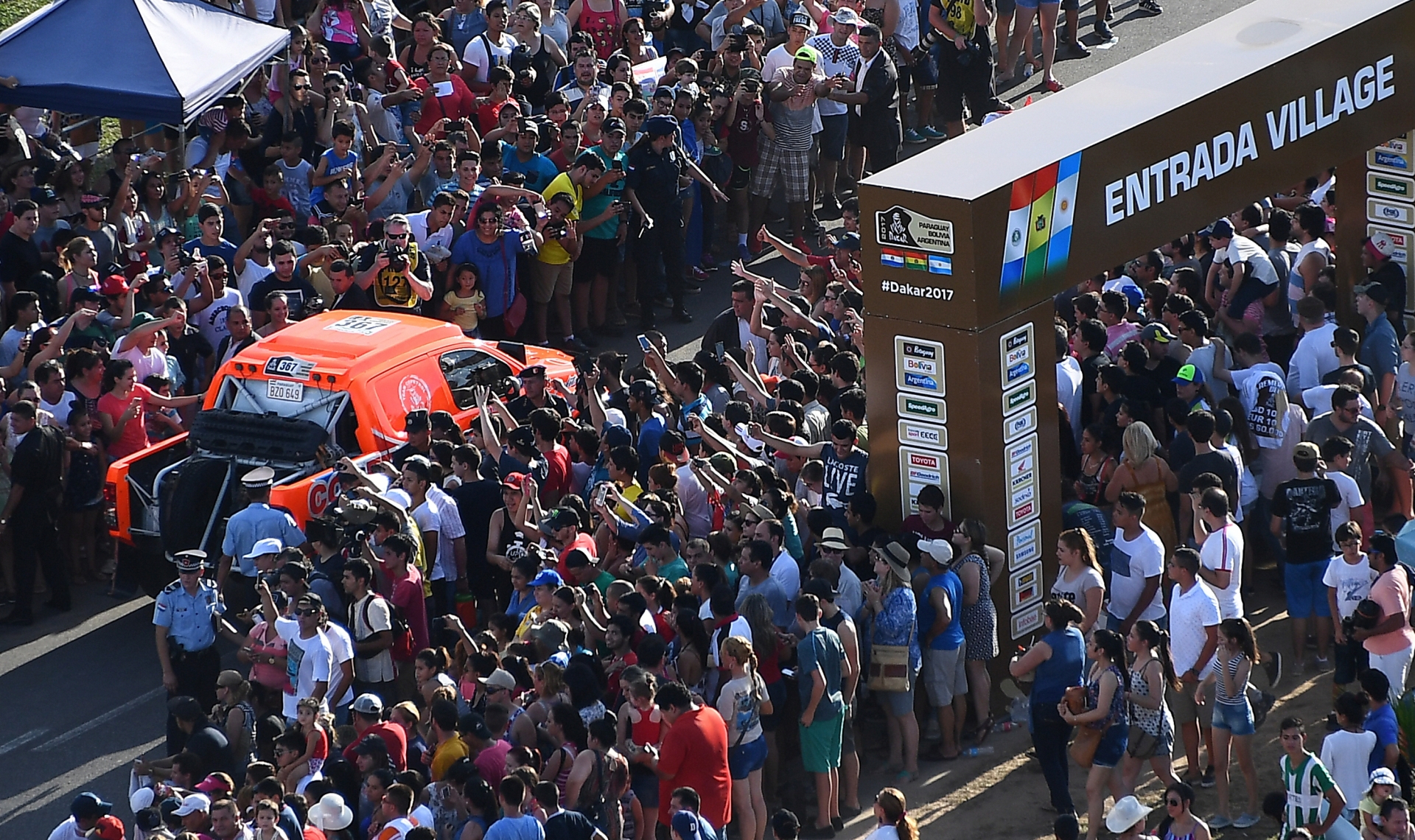 The car driven by Blas Zapag and Enrique Zapag drives along a street lined with spectators at the Dakar Rally departure ceremony in Asuncion, Paraguay, on Sunday, Jan. 1, 2017. The rally goes through Paraguay, Argentina and Bolivia from Jan. 2 to 14. (Frank Fife/Pool Photo via AP) Dakar Rally Paraguay