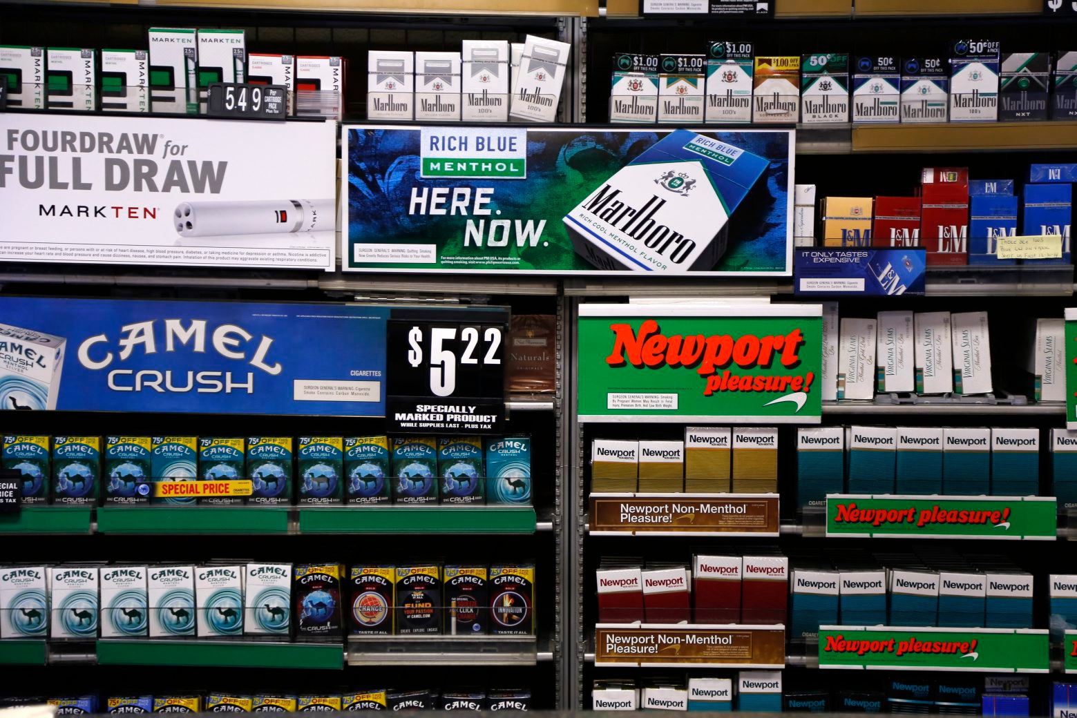 FILE - In this Friday, July 17, 2015 file photo, Camel and Newport cigarettes, both Reynolds American brands, are on display at a Smoker Friendly shop in Pittsburgh. British American Tobacco Plc has agreed to fully take over Reynolds American Inc. on terms that are improved from an initial bid made last year. (AP Photo/Gene J. Puskar, file) Tobacco Merger