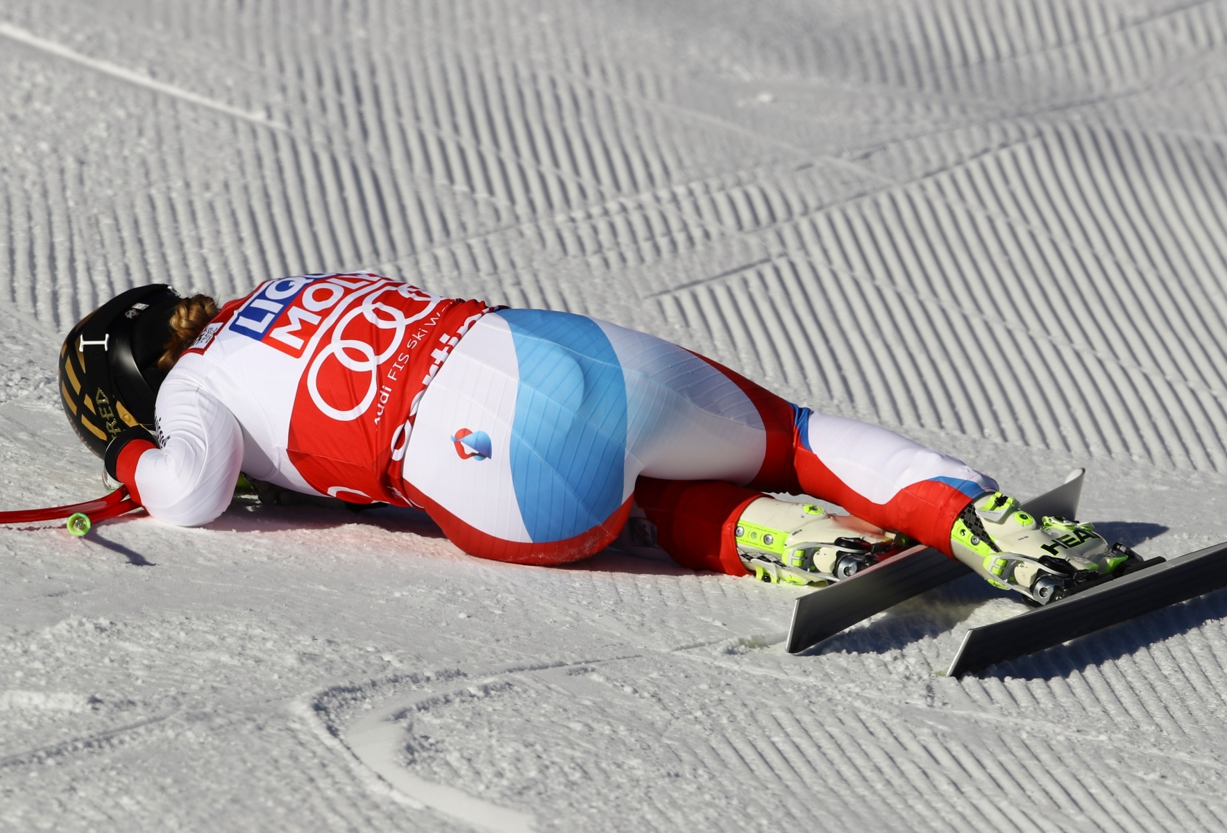 Switzerland's Lara Gut lies in the snow after completing an alpine ski, women's World Cup super-G, in Cortina d'Ampezzo, Italy, Sunday, Jan. 29, 2017. (AP Photo/Alessandro Trovati) Italy Alpine Skiing World Cup