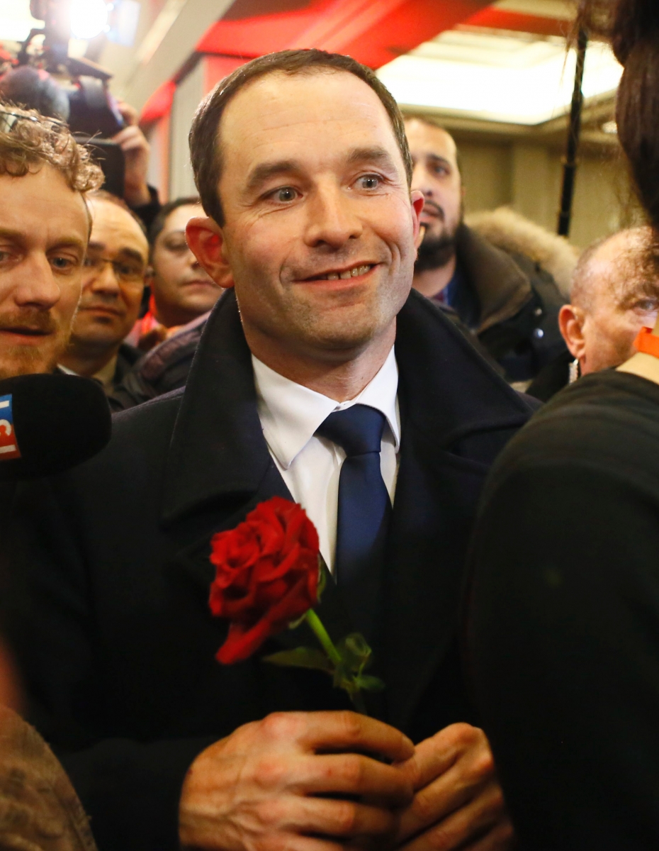 Benoit Hamon greets supporters after winning the socialist party presidential nomination in Paris, France, Sunday, Jan. 29, 2017. Benoit Hamon, rising from left-wing obscurity on a radical proposal to a pay all adults a monthly basic income, will be the Socialist Party candidate in France's presidential election this spring, after he handily beat ex-Prime Minister Manuel Valls in a primary runoff vote Sunday. (AP Photo/Francois Mori) France Election