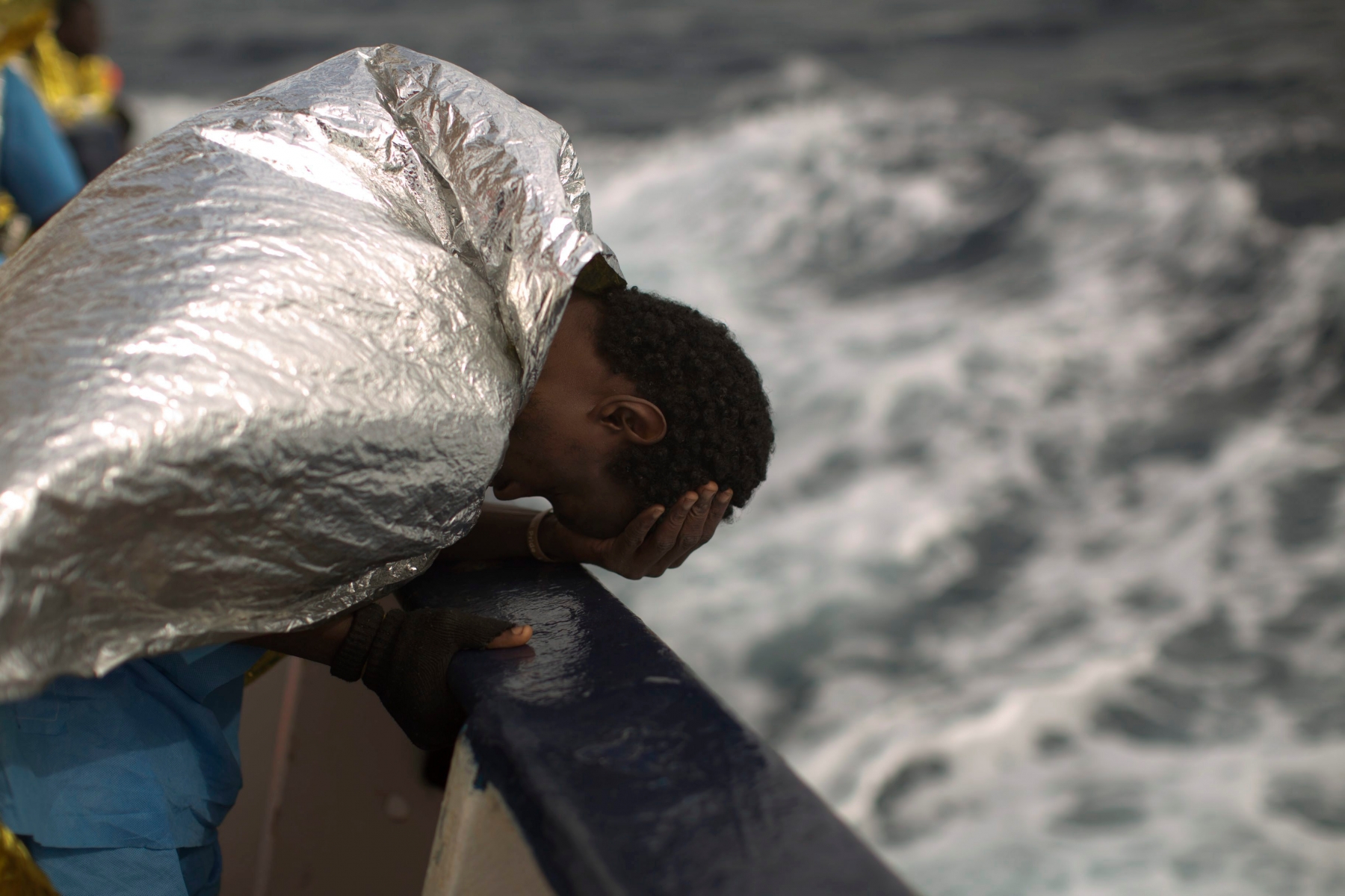A sub-Saharan migrant holds his head, on the deck of the Golfo Azzurro boat after he was rescued from a rubber boat by members of Proactive Open Arms NGO, on the Mediterranean sea, about 24 miles north of Sabratha, Libya, Saturday, Jan. 28, 2017. (AP Photo/Emilio Morenatti) Pictures Of The Week Photo Gallery