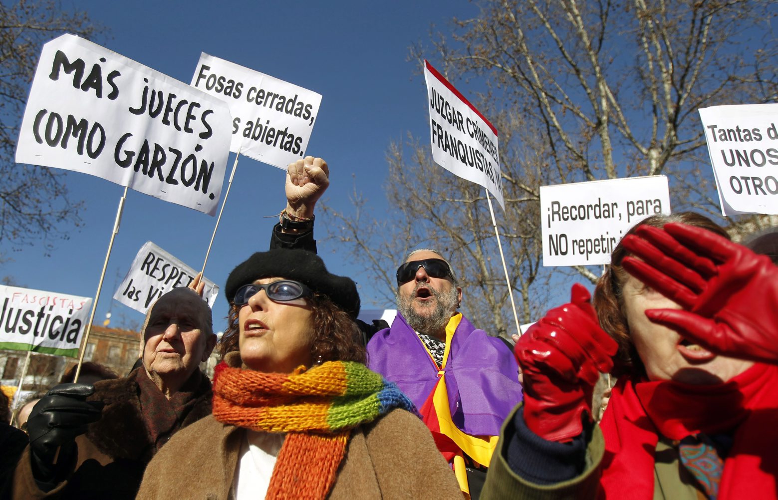 People hold banners reading, from left, "More Judges like Garzon", "Memory, to do not repeat it", "Judge Franco's crimes" during a protest in support of Judge  Garzon in Madrid, Spain, Sunday, Feb. 12, 2012. Thousands have demonstrated Sunday in support of a Spanish judge who won global fame for taking on international human rights cases but who has now been barred from the bench after being convicted of ordering jailhouse wiretaps. Baltasar Garzon, 56, was unanimously convicted on Feb. 9 by a seven-judge panel at the Supreme Court, marking a spectacular fall from grace for the nation's most prominent jurist. (AP Photo/Andres Kudacki) SPANIEN PROZESS BALTASAR GARZON PROTEST