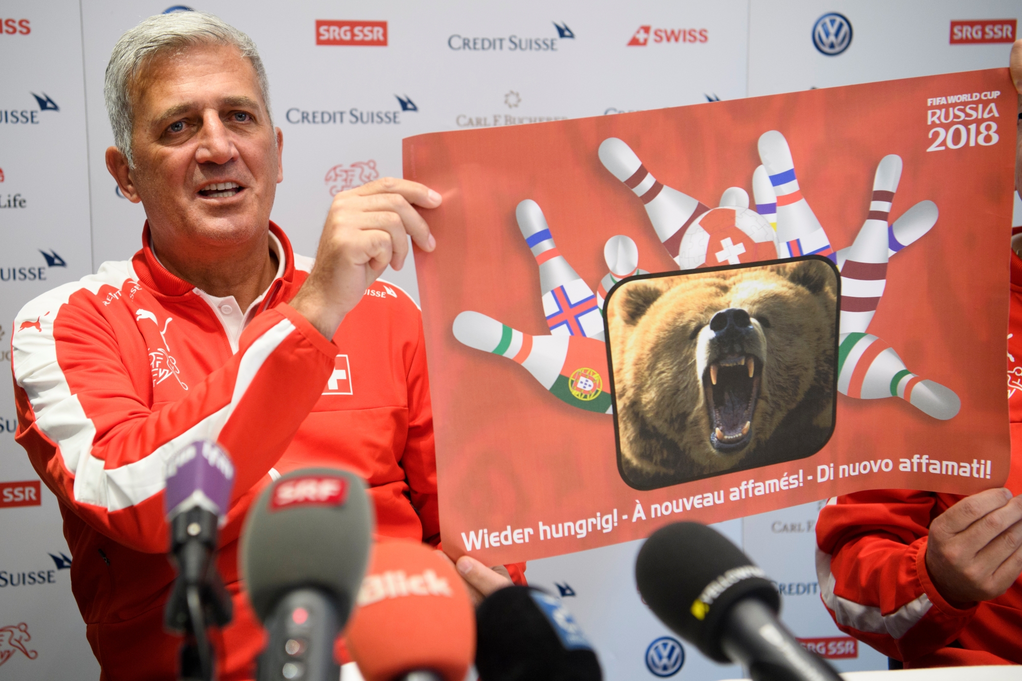 Swiss head coach Vladimir Petkovic shows a poster with a bear during a press conference of the Switzerland soccer national team, in Lausanne, Switzerland, Tuesday, March 21, 2017. Switzerland will plays Latvia next saturday in Geneva for an 2018 Fifa World Cup group B qualification soccer match. (KEYSTONE/Laurent Gillieron) SWITZERLAND SOCCER PRESS CONFERENCE SWISS TEAM