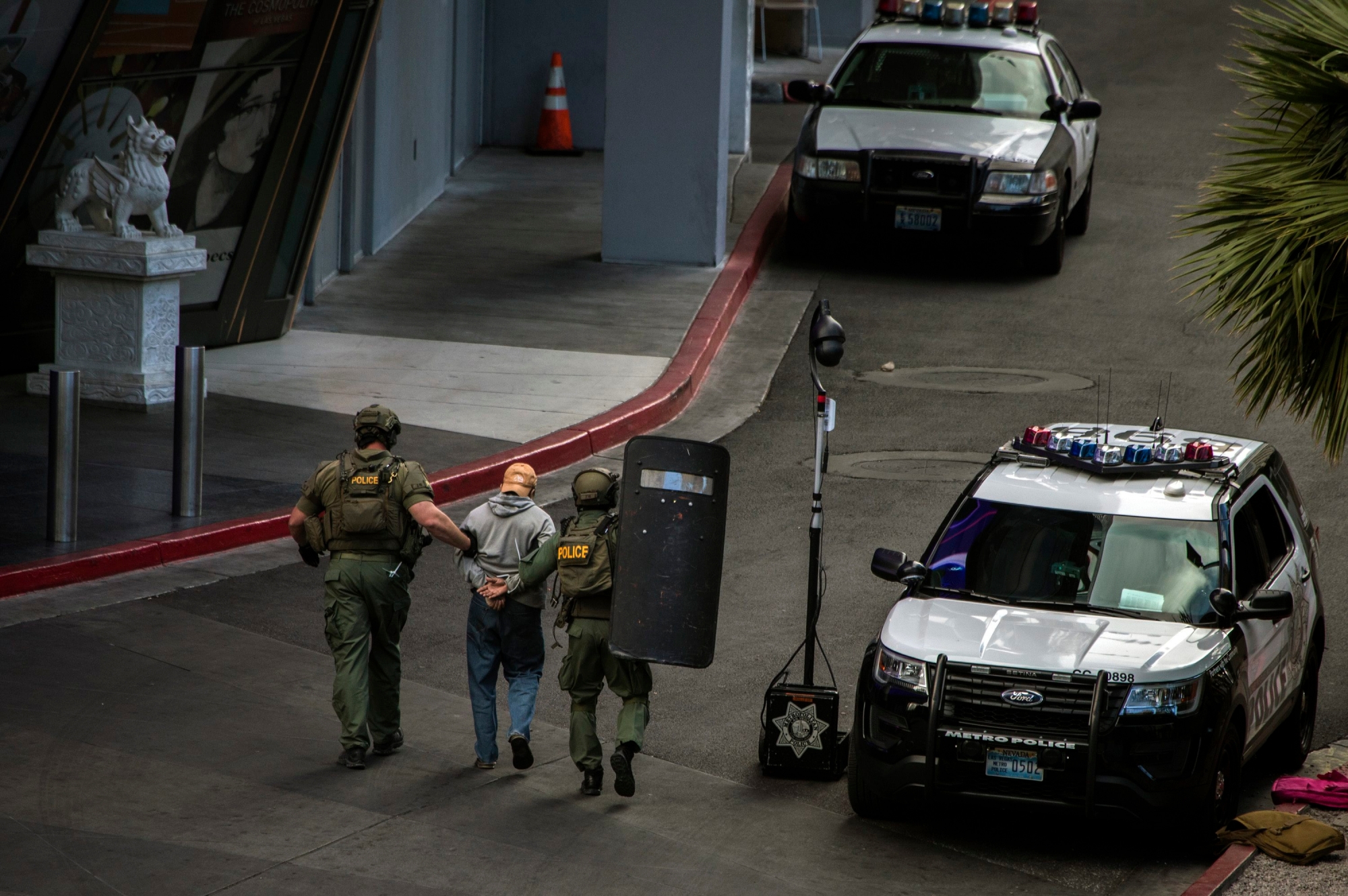 A suspect is taken away after surrendering to SWAT officers after he barricaded himself inside a public bus after a fatal shooting in the vehicle earlier today shutting down the busy tourism corridor near the Cosmopolitan hotel-casino in Las Vegas, Saturday, March 25, 2017. (L.E. Baskow/Las Vegas Sun via AP) APTOPIX Vegas Strip Shooting