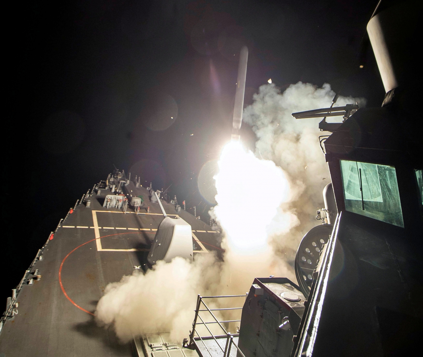 In this image provided by the U.S. Navy, the USS Ross (DDG 71) fires a tomahawk land attack missile Friday, April 7, 2017, from the Mediterranean Sea. The United States blasted a Syrian air base with a barrage of cruise missiles in fiery retaliation for this week's gruesome chemical weapons attack against civilians.  (Mass Communication Specialist 3rd Class Robert S. Price/U.S. Navy via AP) US Syria