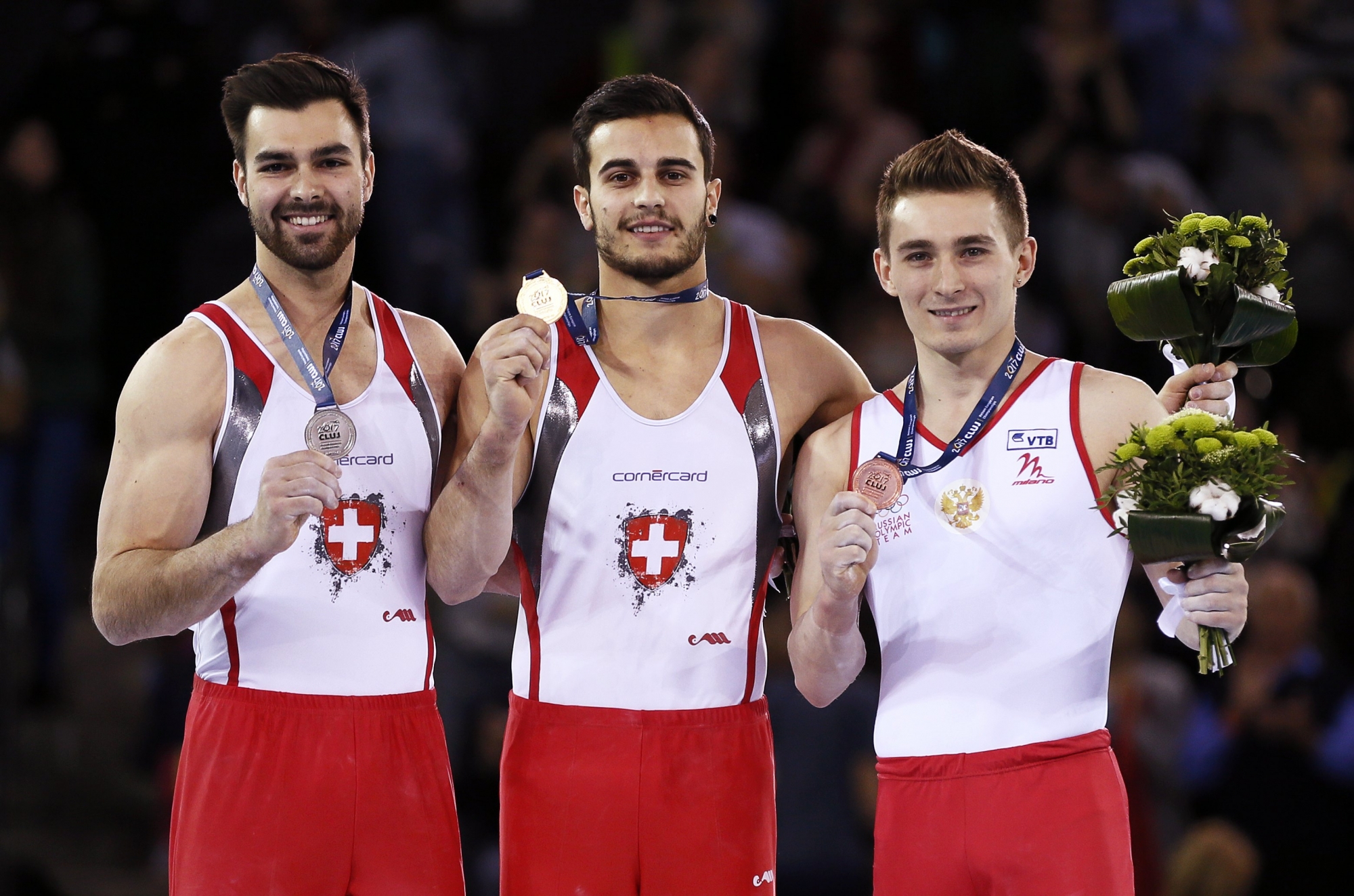 epa05923627 Pablo Braegger of Switzerland (C) poses with his gold medal on the podium after winning the men's high bar final during the 2017 Artistic Gymnastics European Championships at the Polivalenta Sports Hall in Cluj-Napoca, Romania, 23 April 2017. Braegger won ahead of second placed Oliver Hegi of Switzerland (L) and third placed David Belyavskiy (R) of Russia.  EPA/ROBERT GHEMENT ROMANIA EUROPEAN ARTISTIC GYMNASTICS CHAMPIONSHIPS