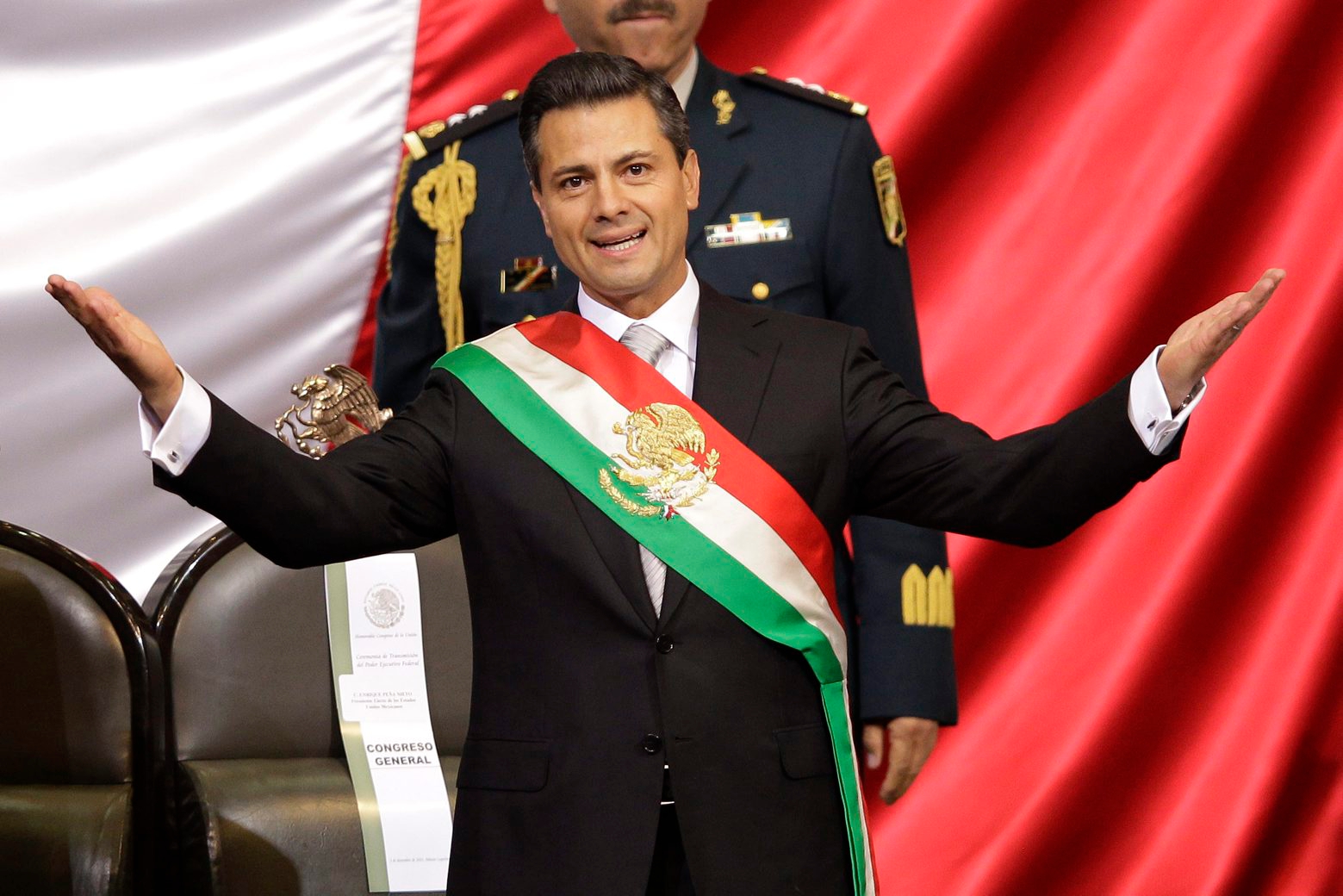 FILE - In this Dec. 1, 2012 file photo, Mexico's incoming President Enrique Pena Nieto of the Institutional Revolution Party, PRI, spreads out his arms after being sworn in at the inauguration ceremony in National Congress, in Mexico City. The PRI ruled Mexico for 71 years, despite accusations of stolen or bought elections, before being ousted in 2000 voting. When it returned to power in 2012 under President Pena Nieto, its leaders couldn't stop talking about how their party had changed. (AP Photo/Alexandre Meneghini, File) Mexico Embattled Ruling Party