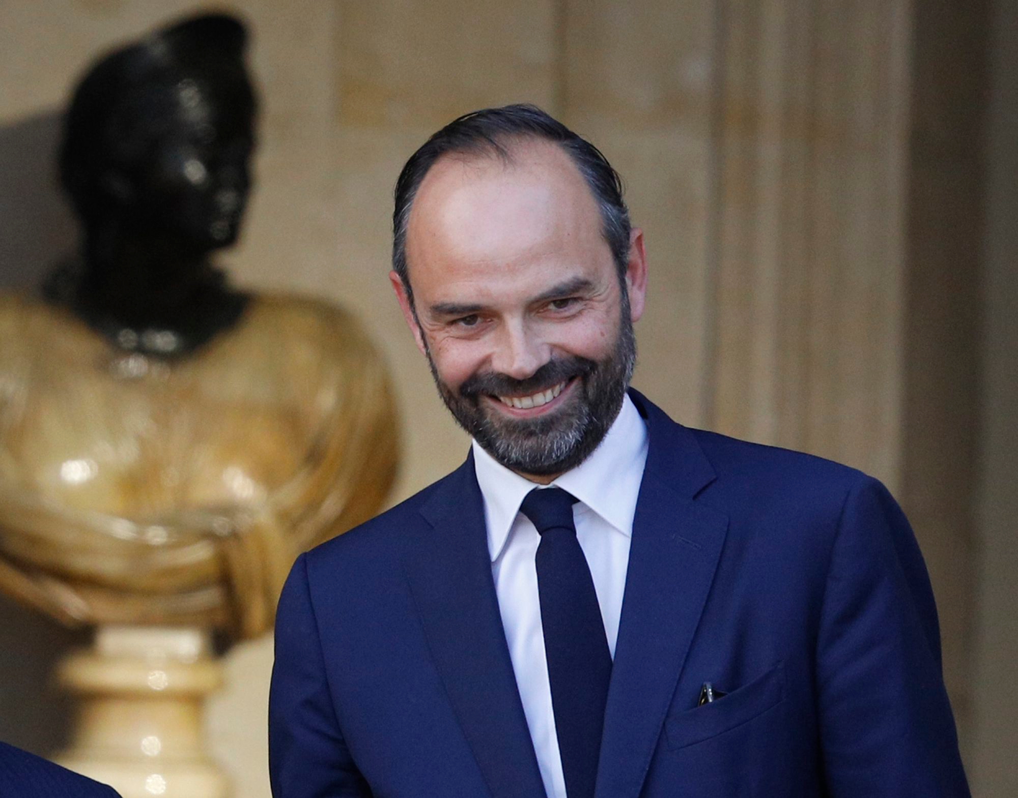 Newly appointed French Prime Minister Edouard Philippe, right, is greeted by outgoing Prime Minister, Bernard Cazeneuve, prior to their meeting in Paris, France, Monday, May 15, 2017. On his first full day in office, French President Emmanuel Macron moved quickly Monday on fronts both foreign and domestic, naming 46-year-old lawmaker Edouard Philippe as his new prime minister before flying off to Berlin for talks with Chancellor Angela Merkel. (AP Photo/Kamil Zihnioglu) France President