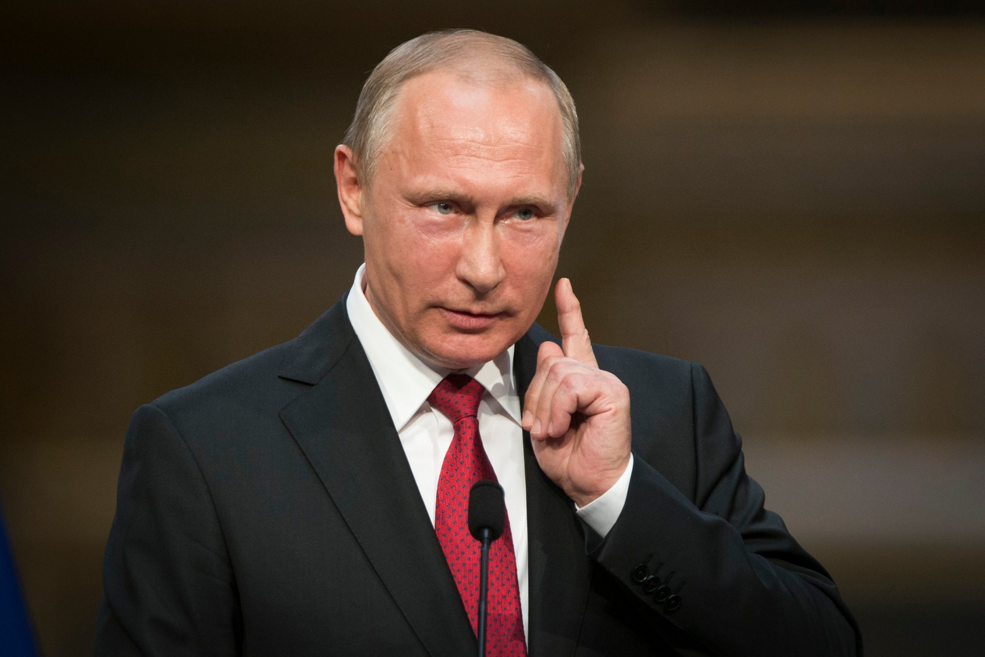 In this photo taken on Monday, May 29, 2017, Russian President Vladimir Putin gestures as he speaks during a shared news conference with French President Emmanuel Macron at the Palace of Versailles, near Paris, France. Putin says the allegations of Russian meddling in the U.S. presidential election are "fiction" invented by the Democrats in order to explain their loss. (AP Photo/Alexander Zemlianichenko) Trump Russia Probe