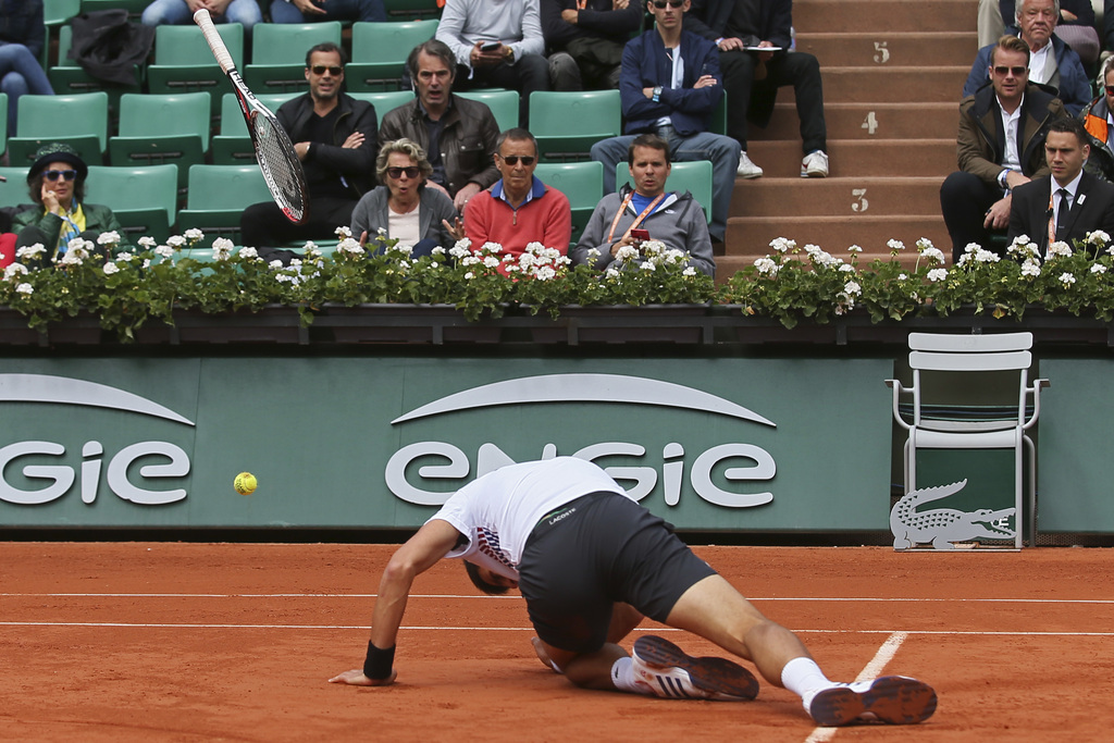 Serbia's Novak Djokovic slips in his quarterfinal match of the French Open tennis tournament against Austria's Dominic Thiem at the Roland Garros stadium, in Paris, France. Wednesday, June 7, 2017. (AP Photo/David Vincent)