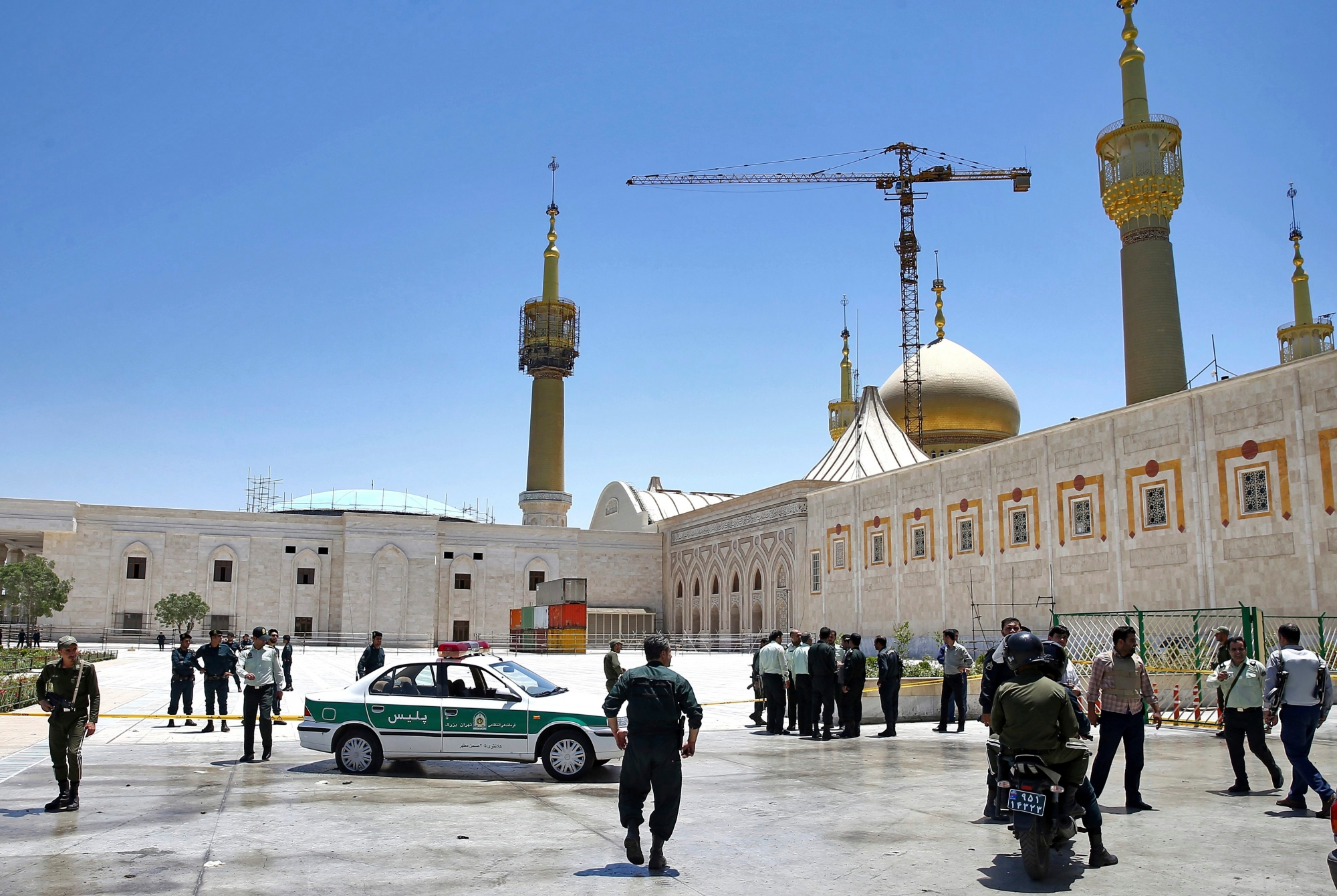 Police officers control the scene, around of shrine of late Iranian revolutionary founder Ayatollah Khomeini, after an assault by several attackers in Tehran, just outside Tehran, Iran, Wednesday, June 7, 2017. Suicide bombers and gunmen stormed into Iran's parliament and targeted the shrine of Ayatollah Ruhollah Khomeini on Wednesday, killing a security guard and wounding several other people in rare twin attacks, with the siege at the legislature still underway. (AP Photo/Ebrahim Noroozi) Iran