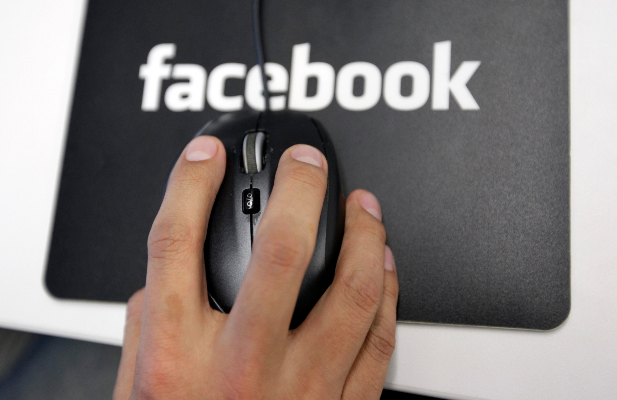 FILE - In this Tuesday, Dec. 13, 2011, file photo, a Facebook User Operations Safety Team worker looks at reviews at Facebook headquarters in Menlo Park, Calif. The Washington Post and The Guardian reported Thursday, June 6, 2013, the existence of a program used by the NSA and FBI that scours the nation's main Internet companies, extracting audio, video, photographs, emails, documents and connection logs to help analysts track a person's movements and contacts. (AP Photo/Paul Sakuma, File) NSA Phone Records