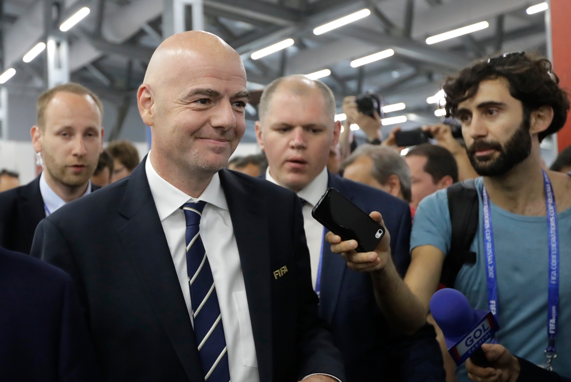 Surrounded by officials FIFA President Gianni Infantino seen during his visit to Media centre prior the Group A soccer match between Portugal and Mexico, at the Kazan Arena, Russia, Sunday, June 18, 2017. (AP Photo/Sergei Grits) Soccer Confed Cup Portugal Mexico