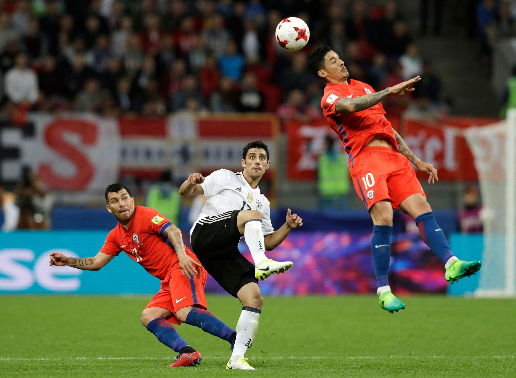 Germany's Lars Stindl, center, looks to Chile's Pablo Hernandez, right, during the Confederations Cup, Group B soccer match between Germany and Chile, at the Kazan Arena, Russia, Thursday, June 22, 2017. (AP Photo/Thanassis Stavrakis) Soccer Confed Cup Germany Chile