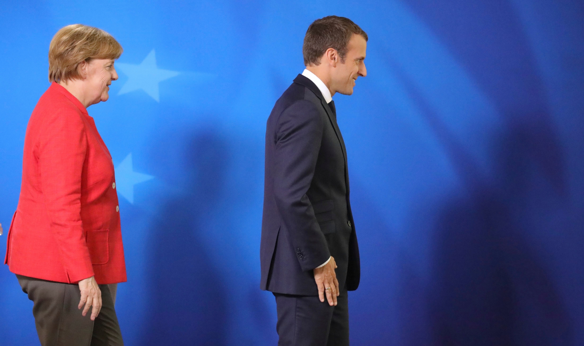 German Chancellor Angela Merkel, left, and French President Emmanuel Macron leave the podium after addressing the media at an EU summit in Brussels on Friday, June 23, 2017. European Union leaders met in Brussels on the final day of their two-day summit to focus on ways to stop migrants crossing the Mediterranean and how to uphold free trade while preventing dumping on Europe's markets. (AP Photo/Olivier Matthys) Belgium EU Summit