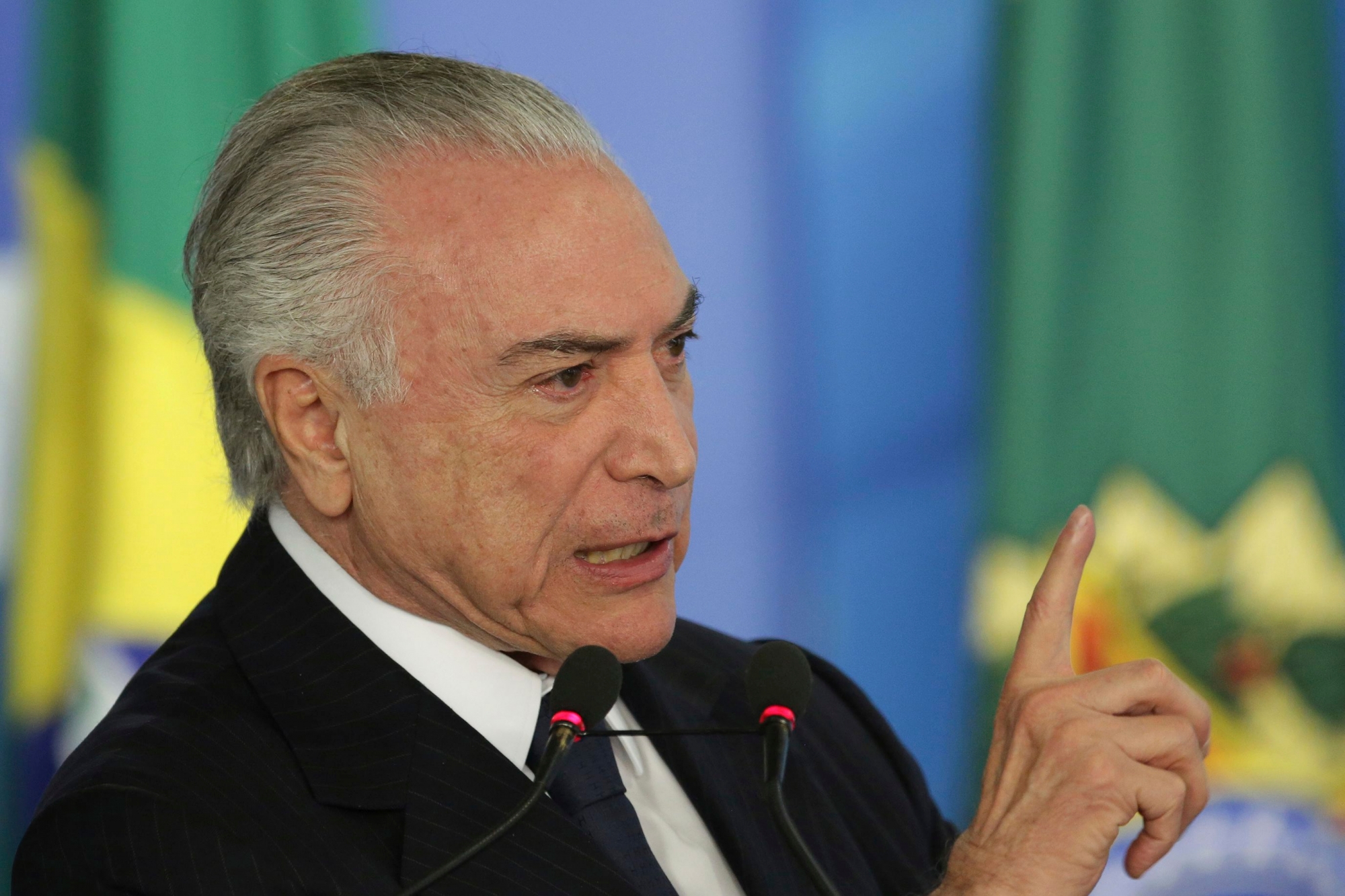 Brazil's President Michel Temer speaks during a ceremony at the Planalto Presidential Palace, in Brasilia, Monday, June 26, 2017. Temer is expressing defiance in the face of possible corruption charges, the lowest approval rating for a Brazilian leader in a generation and calls for his resignation. He says nothing will "destroy" his government. (AP Photo/Eraldo Peres) Brazil Political Crisis