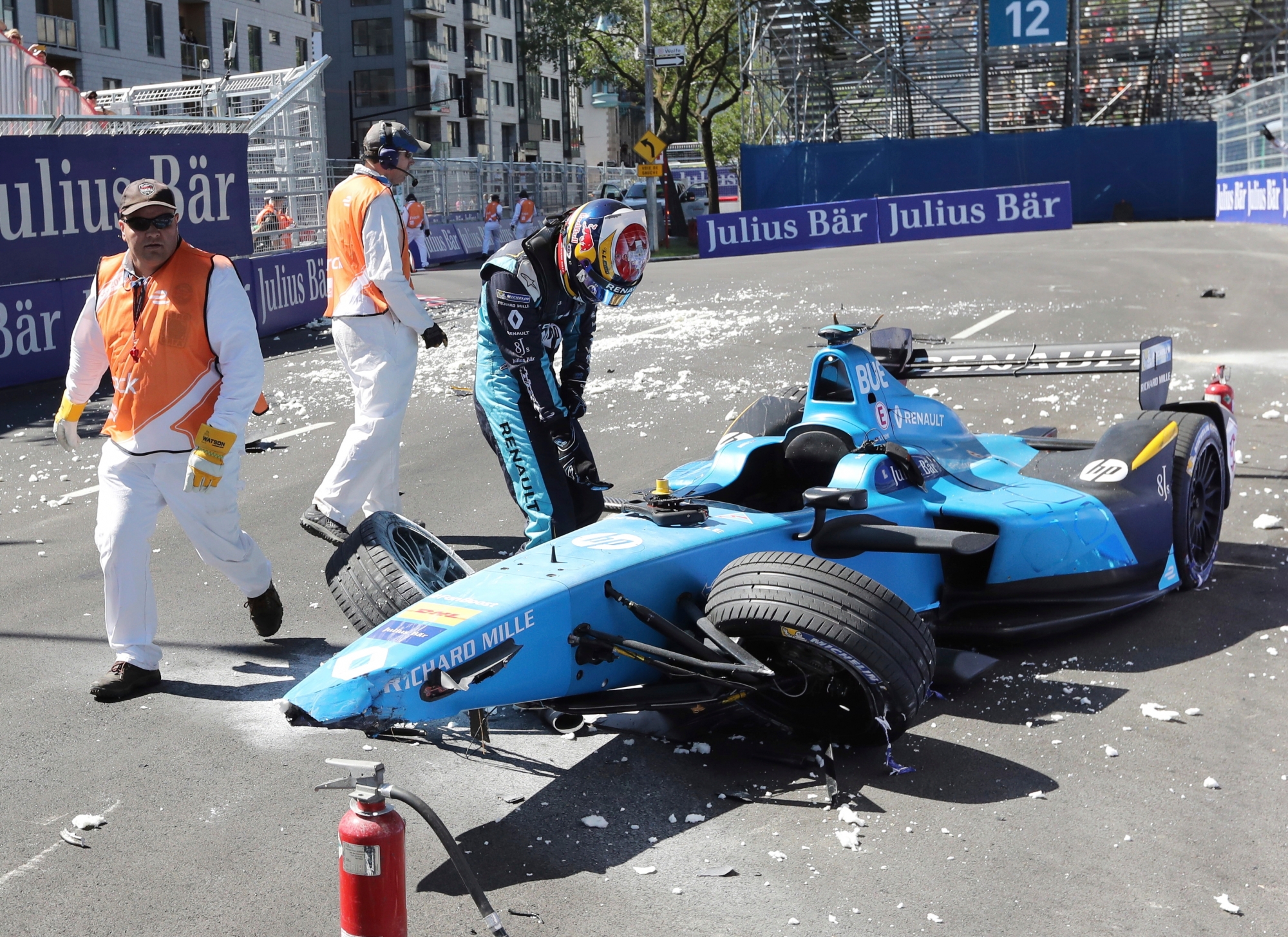 Sebastien Buemi, of Switzerland, checks the damage to his car after crashing during the second practice session at the Montreal Formula ePrix electric car race in Montreal on Saturday, July 29, 2017. (Tom Boland/The Canadian Press via AP) F1 Canada Formula E Auto Racing