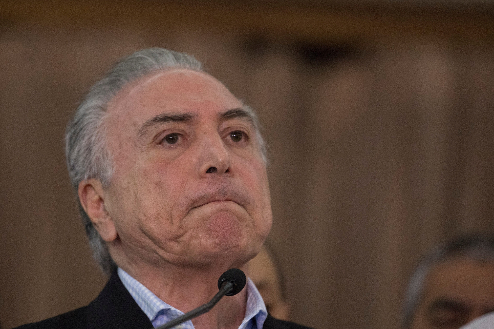 Brazil's president Michel Temer speaks to the press during his visit to the operations control center at the Army's headquarters in Rio de Janeiro, Brazil, Sunday, July. 30, 2017. Thousands of soldiers began patrolling Rio de Janeiro amid a spike in violence in Brazil's second-largest city. (AP Photo/Leo Correa) Brazil Security