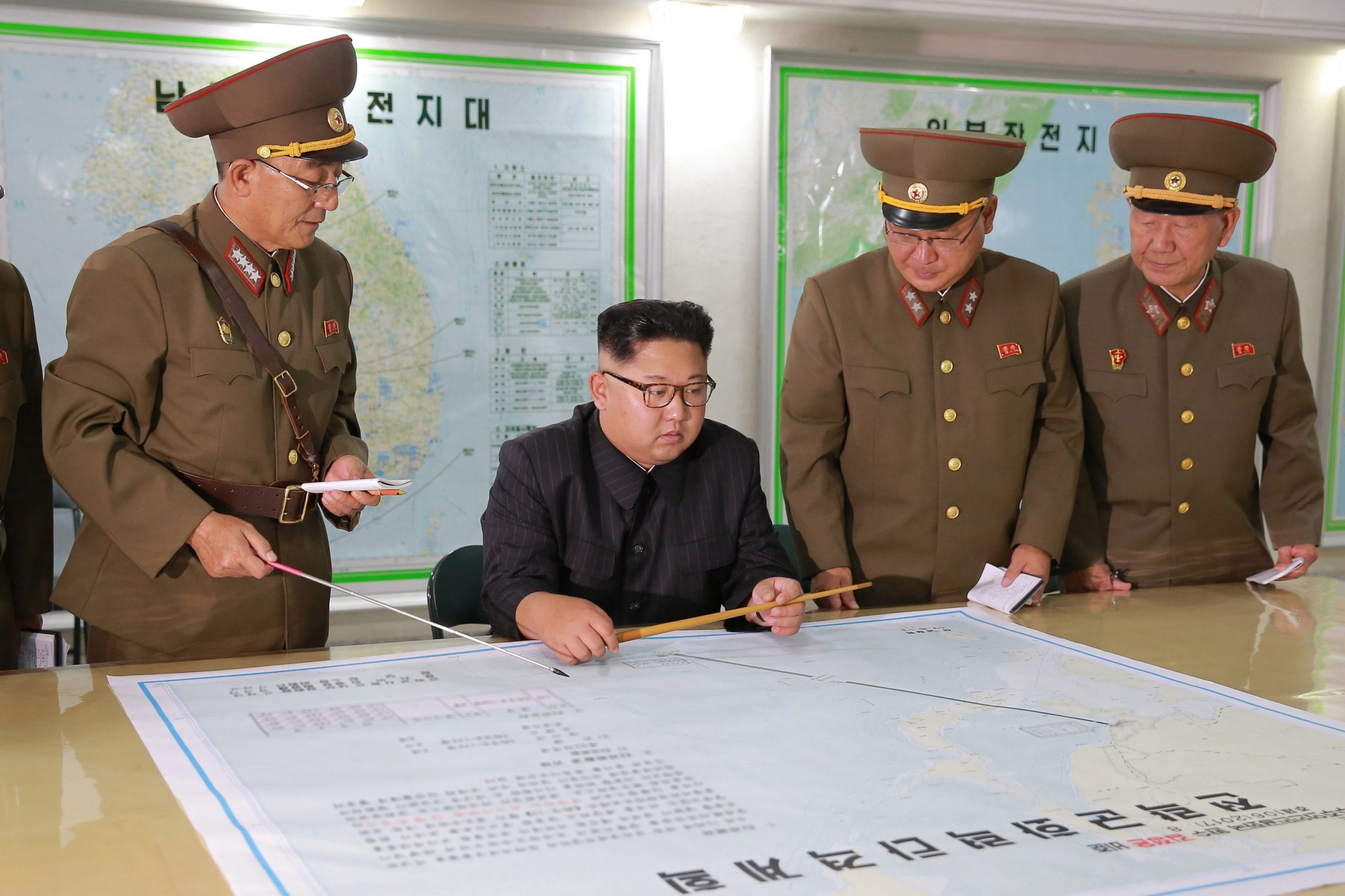 epa06145192 A picture released by the North Korean Central News Agency (KCNA) North Korean leader Kim Jong Un inspecting plans to fire missiles towards the US Pacific territory of Guam at the Command of the Strategic Force of the Korean People's Army (KPA), Pyongyang, DPRK: North Korean 14 August 2017, (issued 15 August 2017). According to North Korean state media on 09 August 2017, the North is considering a potential pre-emptive strike with medium-to-long-range strategic ballistic missiles on Guam, where US tactical bombers are based. The threat follows US President Donald J. Trump's warning to Pyongyang that any threat to the USA 'will be met with fire and fury like the world has never seen.' The exchanges marked rising tensions between the two countries.  EPA/KCNA NORTH KOREA KIM JONG UN INSPECTS MILITARY PLANS