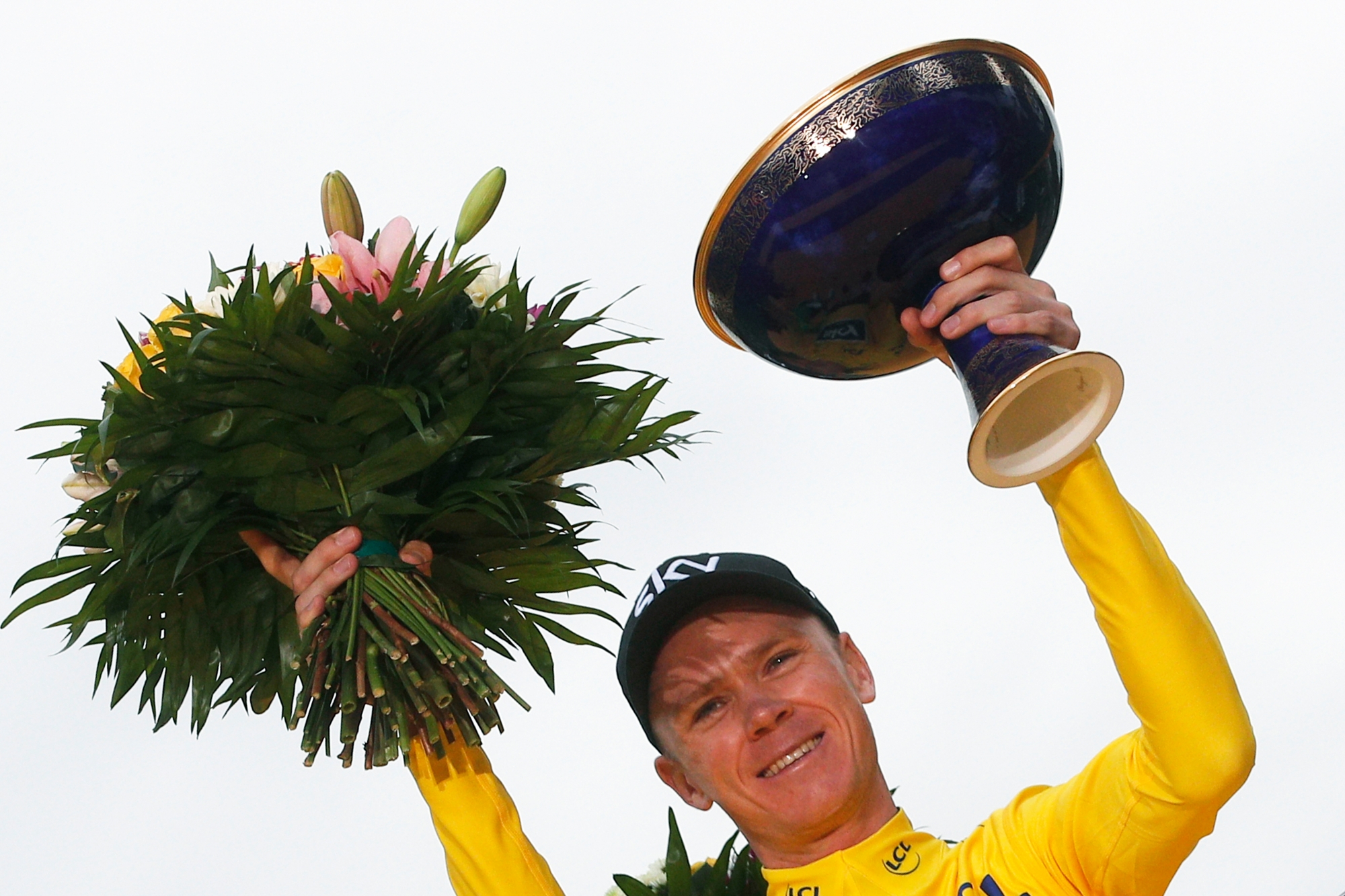 FILE - In this Sunday, July 23, 2017 file photo, Tour de France winner Britain's Chris Froome, wearing the overall leader's yellow jersey, holds the trophy on the podium after the twenty-first and last stage of the Tour de France cycling race over 103 kilometers (64 miles) with start in Montgeron and finish in Paris, France. After winning the Tour de France for a fourth time, Chris Froome now will try to break his run of second-place finishes at the Spanish Vuelta which starts Saturday Aug. 19, 2017. (AP Photo/Christophe Ena, File) Spanish Vuelta Preview