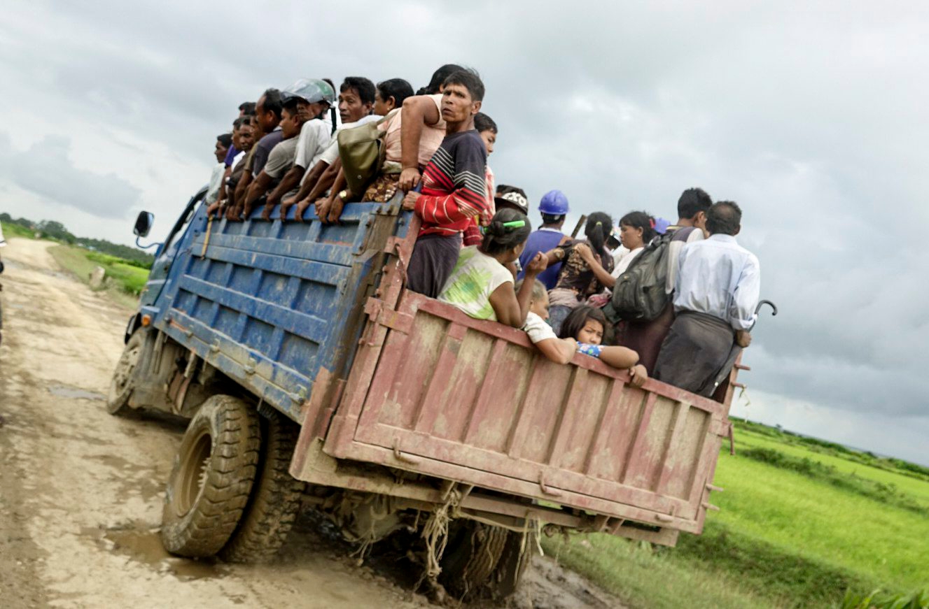epa06161936 Residents ride a truck as they leave an area close to fighting to seek safe place at Rathedaung township of northern Rakhine State, western Myanmar, 25 August 2017. According to a statement by the Myanmar Armed Forces, at least 32 people, including 11 law enforcement officials, were killed on 25 August in Myanmar after Rohingya militants attacked police outposts and an army base in the western state of Rakhine.  EPA/NYUNT WIN MYANMAR RAKHINE STATE UNREST
