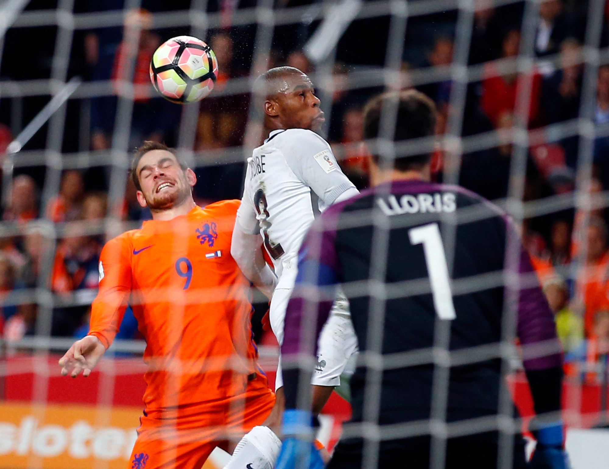 Netherlands' Vincent Janssen, left, heads the ball with France's Djibril Sidibe, center, while France's goalkeeper Hugo Lloris looks on  during the World Cup Group A qualifying soccer match in the ArenA stadium in Amsterdam, Netherlands, Monday, Oct. 10, 2016. France defeated Netherlands 1-0. (AP Photo/Peter Dejong)bv SOCCER WCUP 2018 NETHERLANDS FRANCE