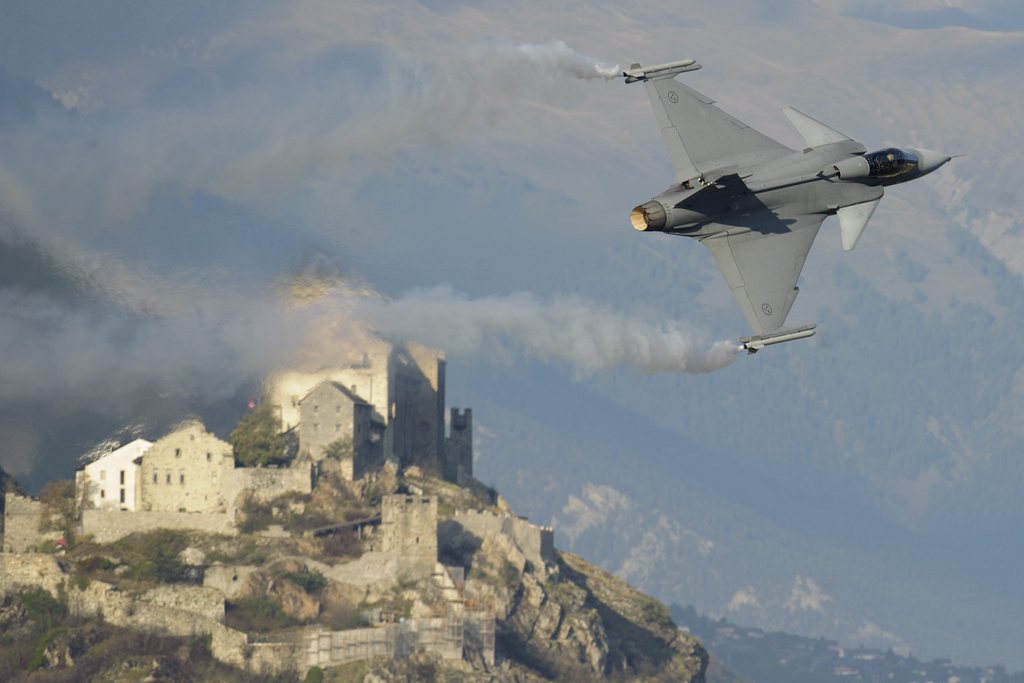 A Swedish Gripen aircraft fighter flies during the first day of the airshow of Sion, Switzerland, Friday, September 16, 2011. The Sion air show will take place in middle of the Swiss alps, in Sion, from September 16 to 18. (KEYSTONE/Laurent Gillieron)