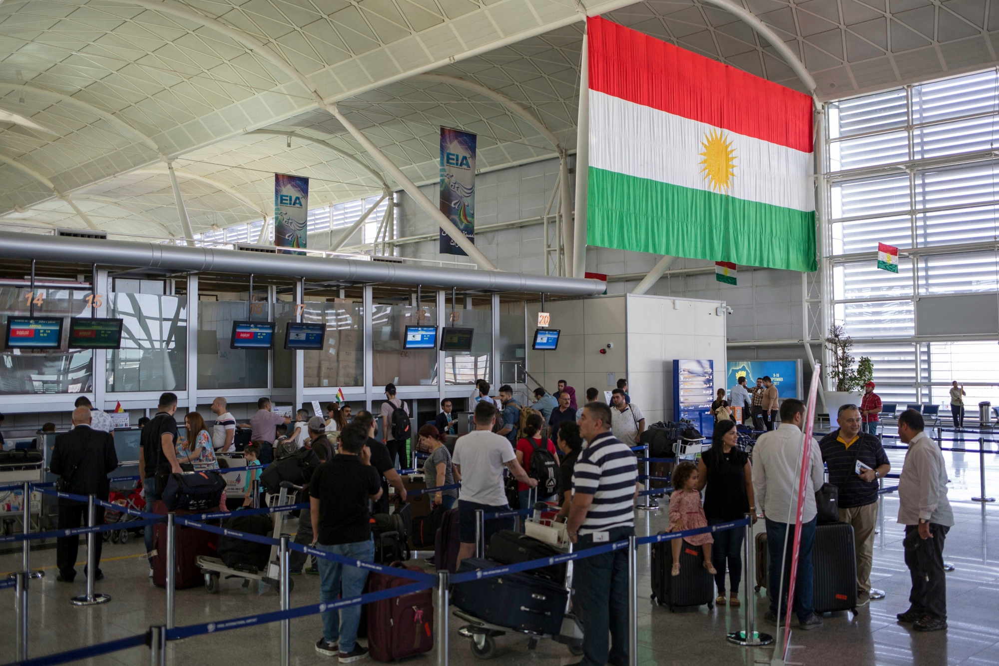 Travelers line up to check in at the Irbil International Airport, in Iraq, Wednesday, Sept. 27, 2017. Iraq's prime minister ordered the country's Kurdish region to hand over control of its airports to federal authorities or face a flight ban, a response to the Kurdish independence referendum. (AP Photo/Bram Janssen) Iraq