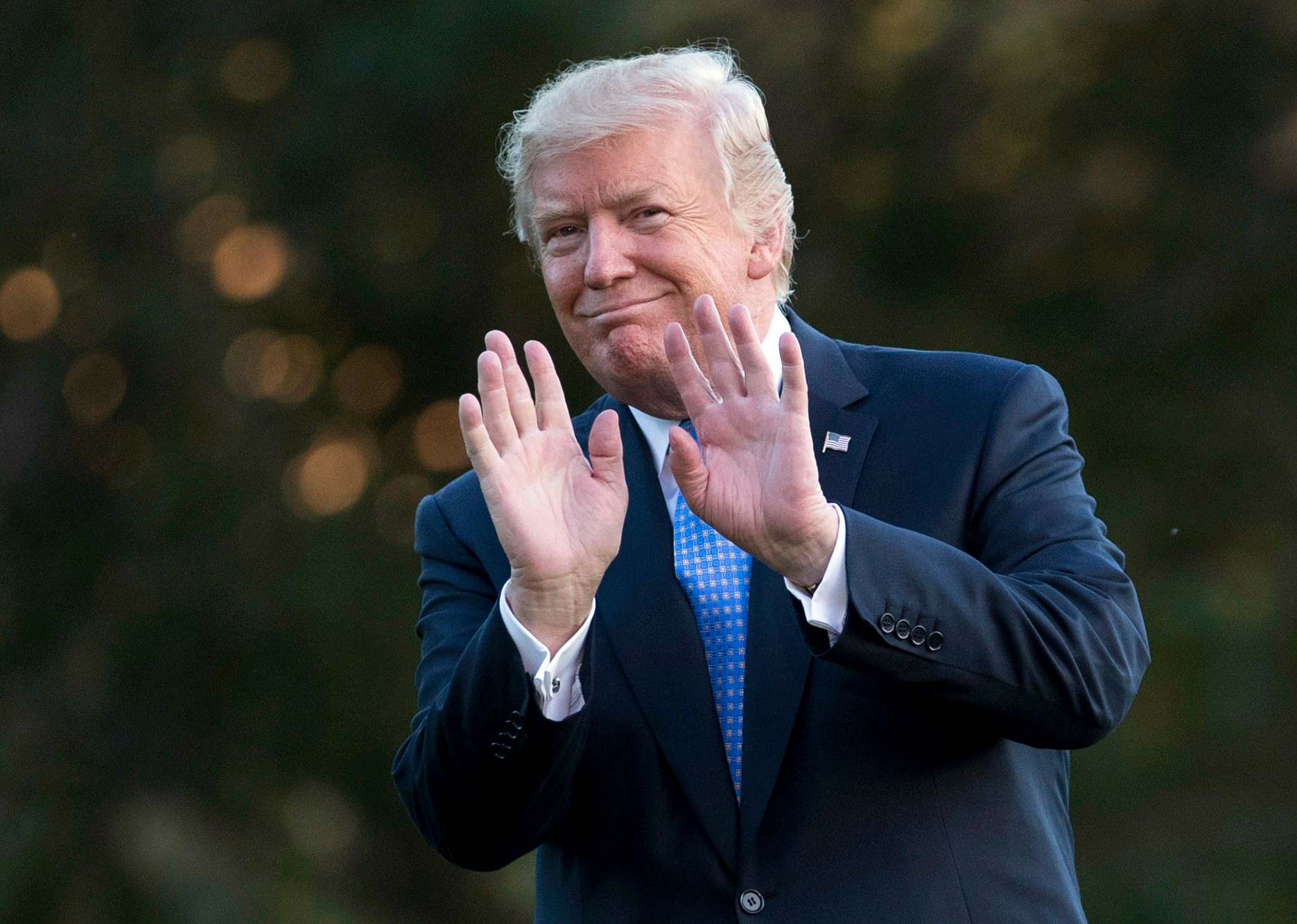 President Donald Trump gestures as he walks from Marine One across the South Lawn of the White House in Washington, Wednesday, Sept. 27, 2017, as he returns from Indianapolis. (AP Photo/Carolyn Kaster) Trump