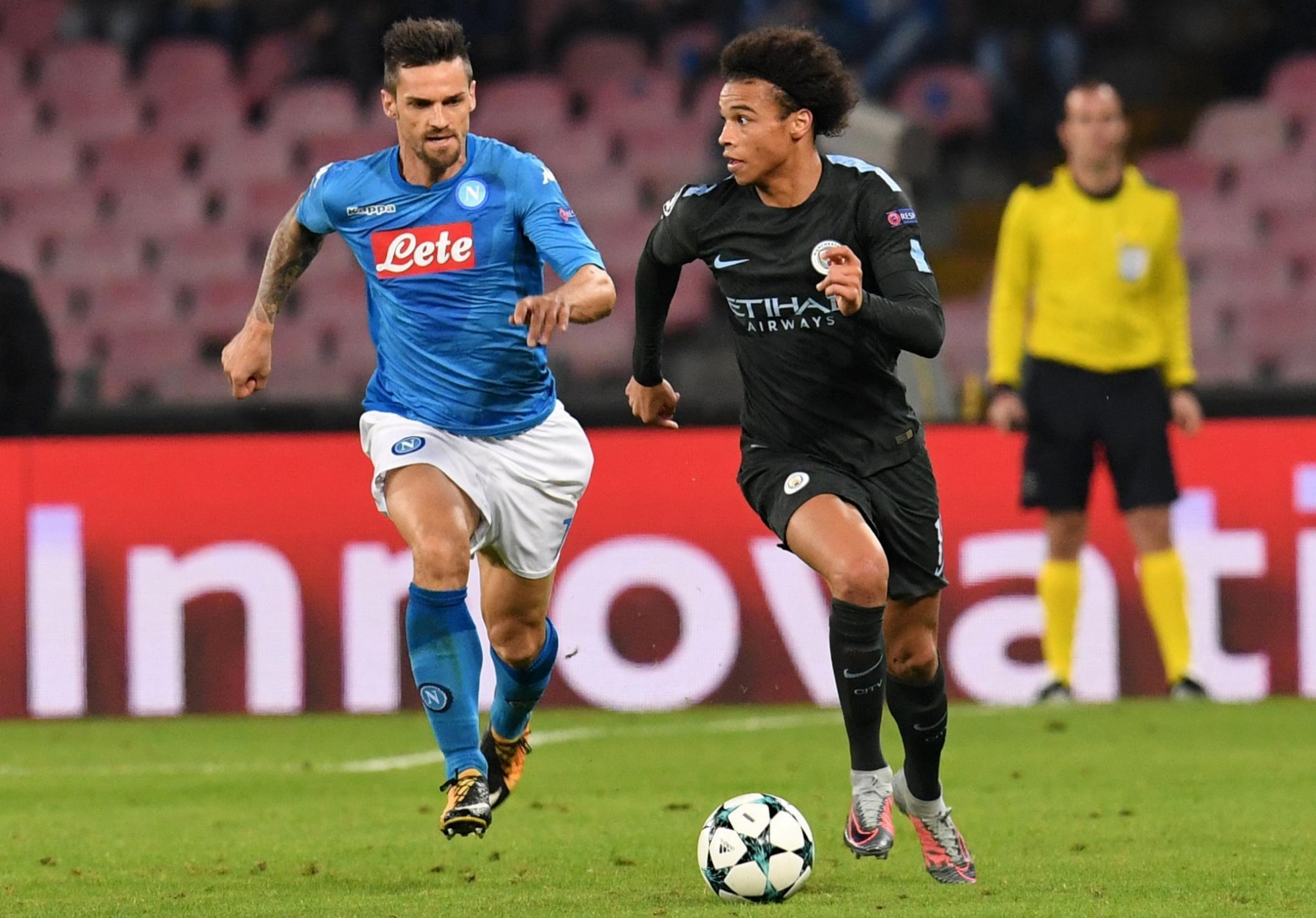 Napoli's Christian Maggio, left, and Manchester City's Leroy Sane' go for the ball during the Champions League Group F soccer match between Napoli and Manchester City, at the San Paolo stadium in Naples, Italy, Wednesday, Nov. 1, 2017. (Ciro Fusco/ANSA via AP) Italy Soccer Champions League