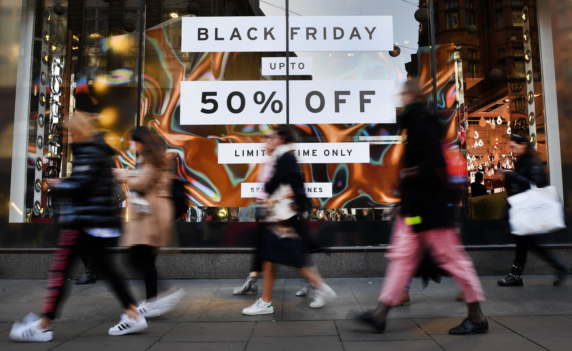 epa06345692 Shoppers walk past a store offering Black Friday sales in London,  Britain, 23 November 2017. According to economic forecasts the UK is set to undergo five years of negative growth. UK earnings in 2022 could still be less than in when the financial crisis hit in 2008.  EPA/ANDY RAIN BRITAIN BUDGET ECONOMY FORECAST