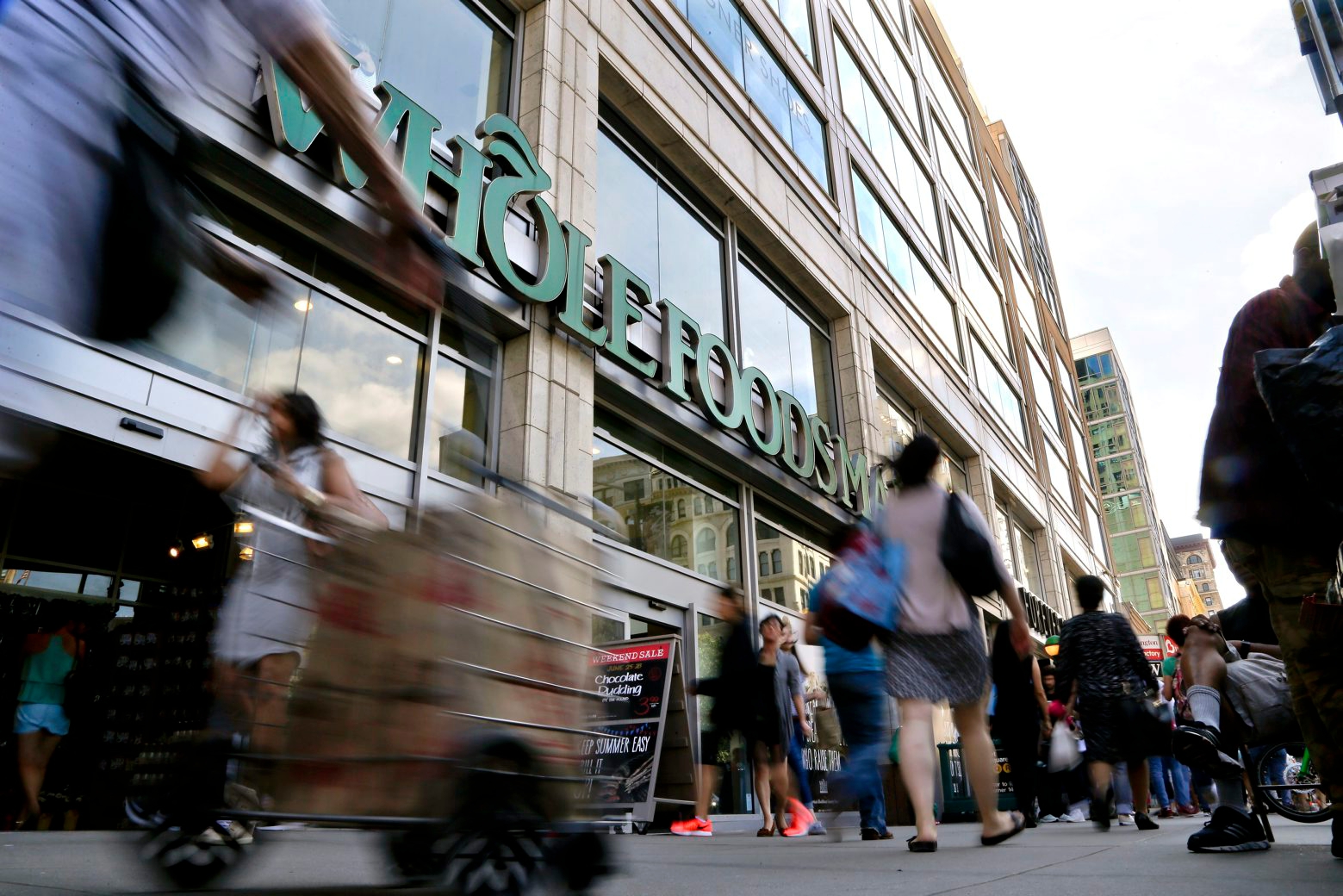 FILE - In this Wednesday, June 24, 2015, file photo, pedestrians pass in front of a Whole Foods Market store in Union Square,  in New York. On Wednesday, Feb. 10, 2016, Whole Foods Market Inc. reports financial results. (AP Photo/Julie Jacobson, File) Earns Whole Foods Market Inc