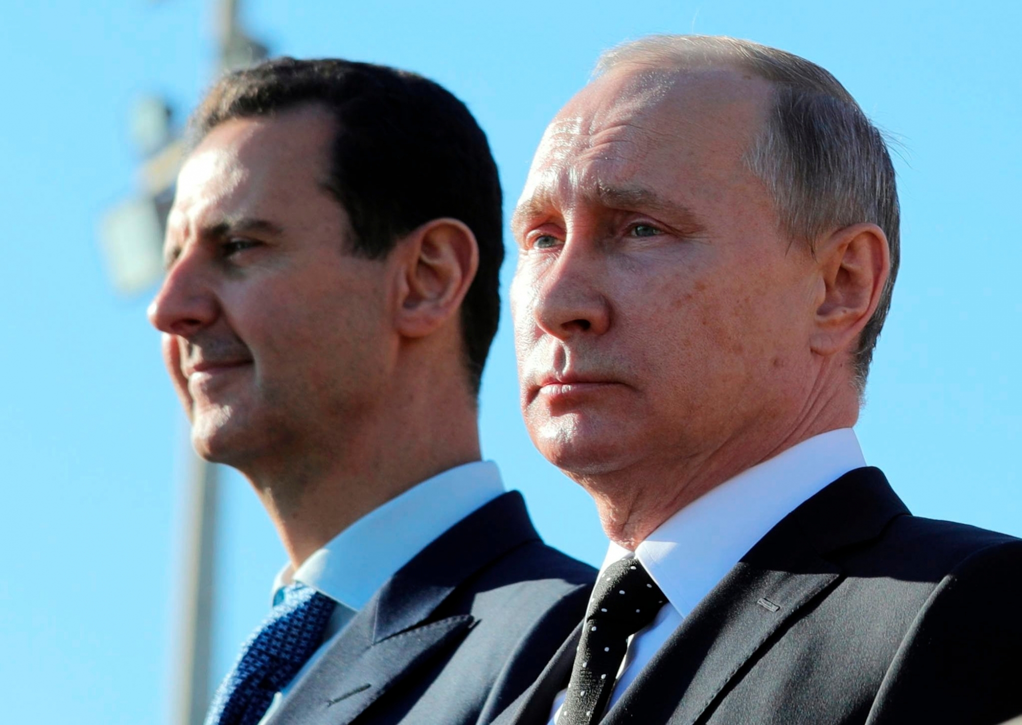 FILE - This Monday, Dec. 11, 2017 file photo, Russian President Vladimir Putin, right, and Syrian President Bashar Assad watch the troops marching at the Hemeimeem air base in Syria. Nearly seven years into the conflict, the war in Syria seems on one level to be winding down, largely because of Russian-backed government victories and local cease-fires aimed at freezing the lines of conflict. (Mikhail Klimentyev, Sputnik, Kremlin Pool Photo via AP, File) Syria Wars End