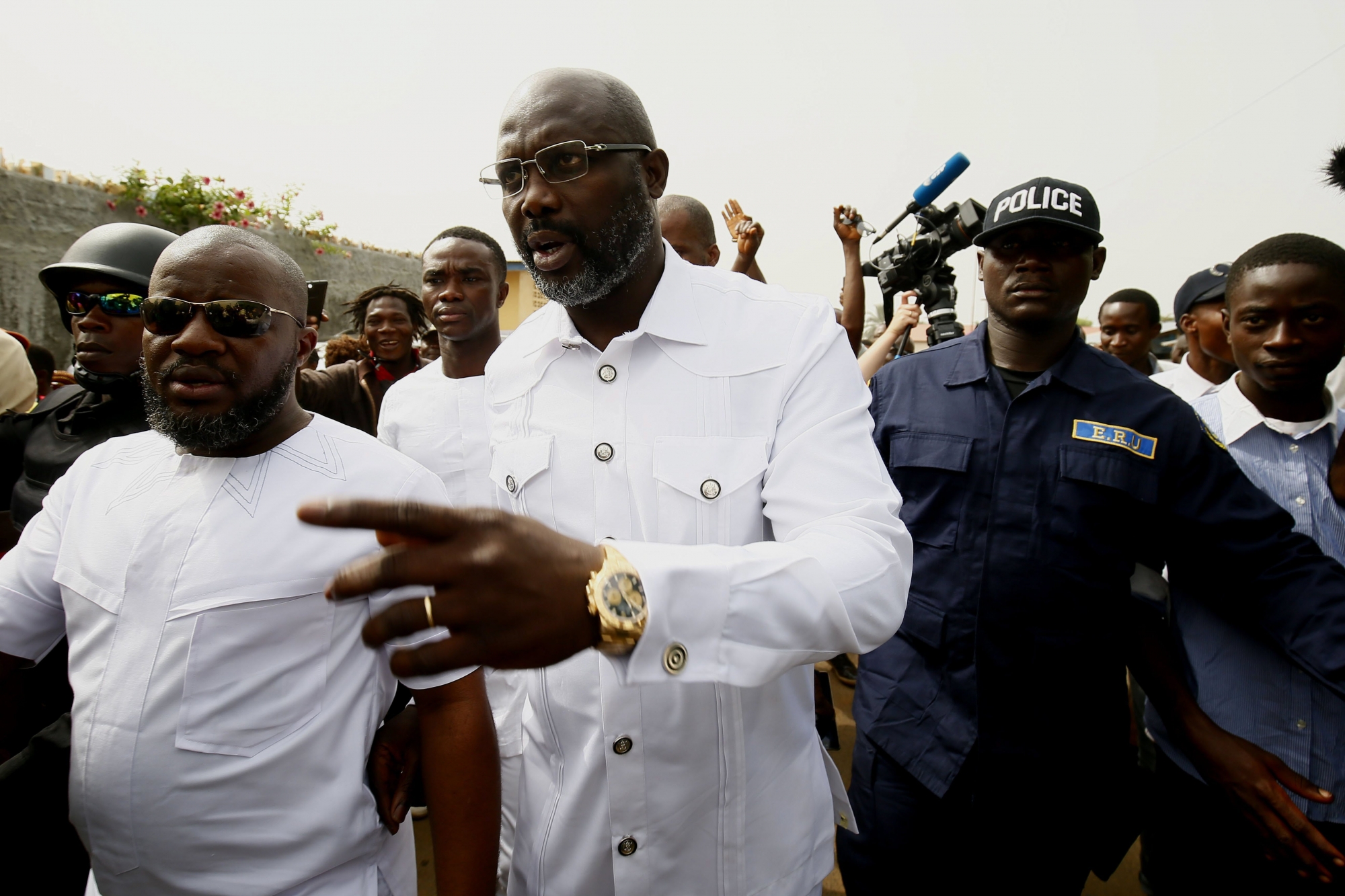 epa06405956 Liberian presidential candidate for the Coalition for Democratic Change (CDC), George Weah (C) leaves a polling station after casting his ballot in presidential elections run-off in Monrovia, Liberia, 26 December 2017. Some 2.1 million registered Liberian voters are eligible to vote in the presidential run-off between George Weah, of the Coalition for Democratic Change (CDC), and Joseph Nyuma Boakai of the governing Unity Party (UP).  EPA/AHMED JALLANZO LIBERIA PRESIDENTIAL EELCTIONS RUN OFF