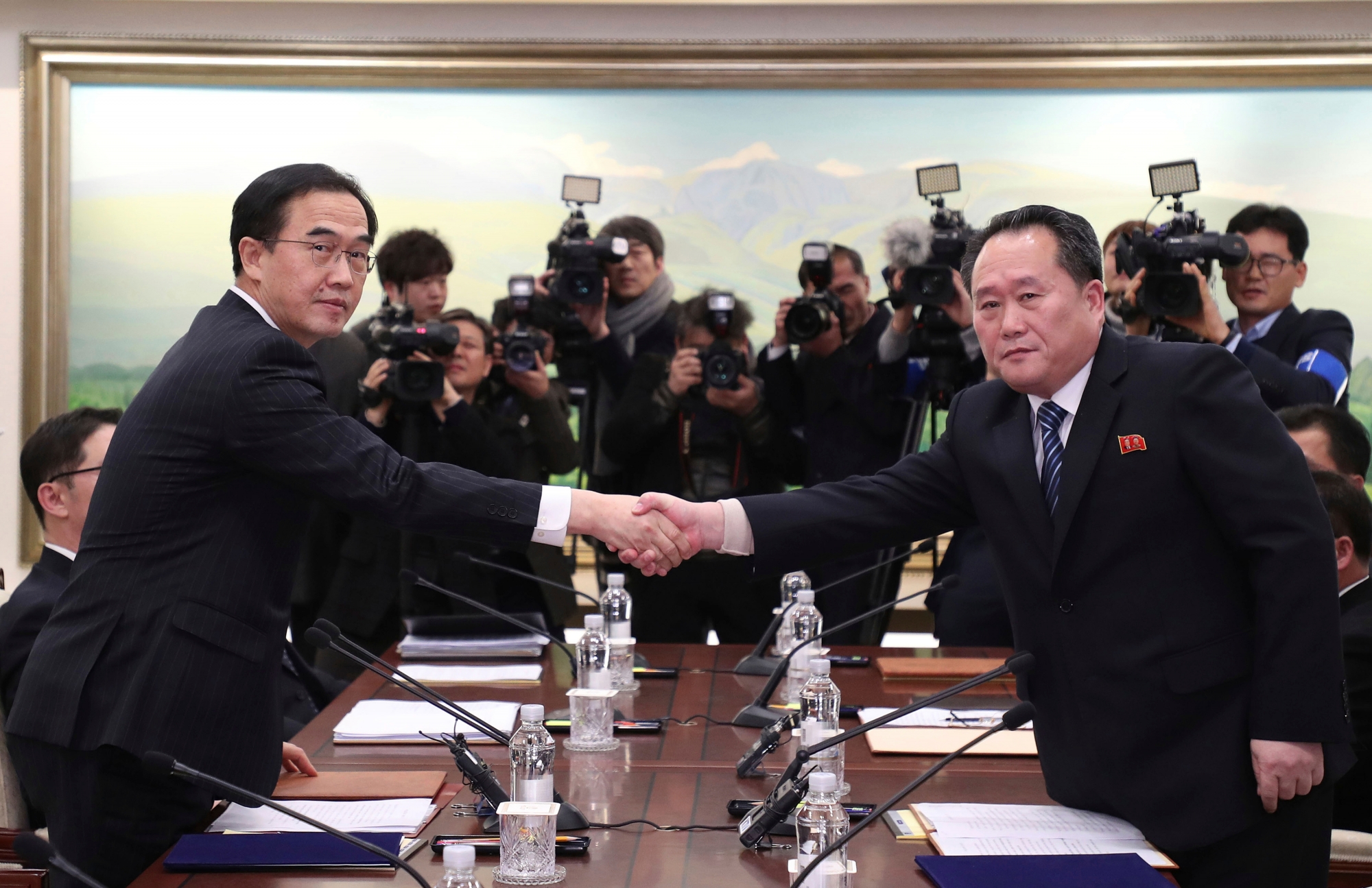 The head of the North Korean delegation Ri Son Gwon, right, shakes hands with South Korean Unification Minister Cho Myoung-gyon after their meeting at Panmunjom in the Demilitarized Zone in Paju, South Korea, Tuesday, Jan. 9, 2018. The rival Koreas took steps toward reducing their bitter animosity during rare talks Tuesday, as North Korea agreed to send a delegation to next month's Winter Olympics in South Korea and reopen a military hotline. (Korea Pool/Yonhap via AP) South Korea Koreas Tensions