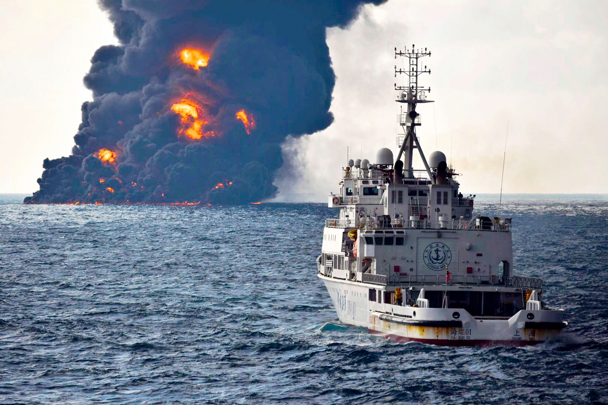 In this Sunday, Jan. 14, 2018, photo provided by China's Ministry of Transport, a rescue ship sails near the burning Iranian oil tanker Sanchi in the East China Sea off the eastern coast of China. The fire from the sunken Iranian tanker ship in the East China Sea has burned out, a Chinese transport ministry spokesman said Monday, although concerns remain about possible major pollution to the sea bed and surrounding waters. (Ministry of Transport via AP) China Sea Collision