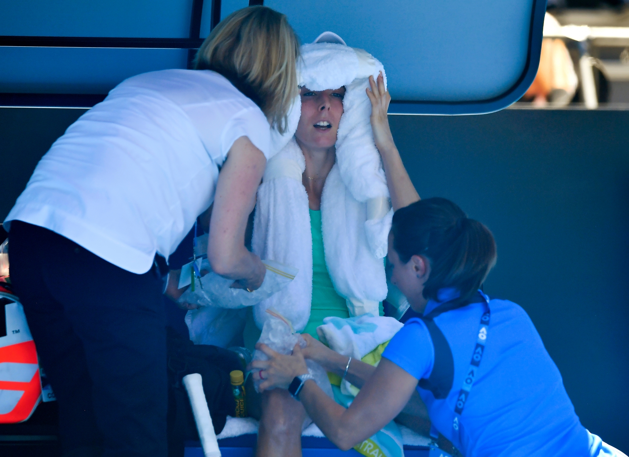 France's Alize Cornet is attended to by a trainer and tournament staff after suffering from the heat during her third round match against Belgium's Elise Mertens at the Australian Open tennis championships in Melbourne, Australia, Friday, Jan. 19, 2018. (AP Photo/Andy Brownbill) APTOPIX Australian Open Tennis