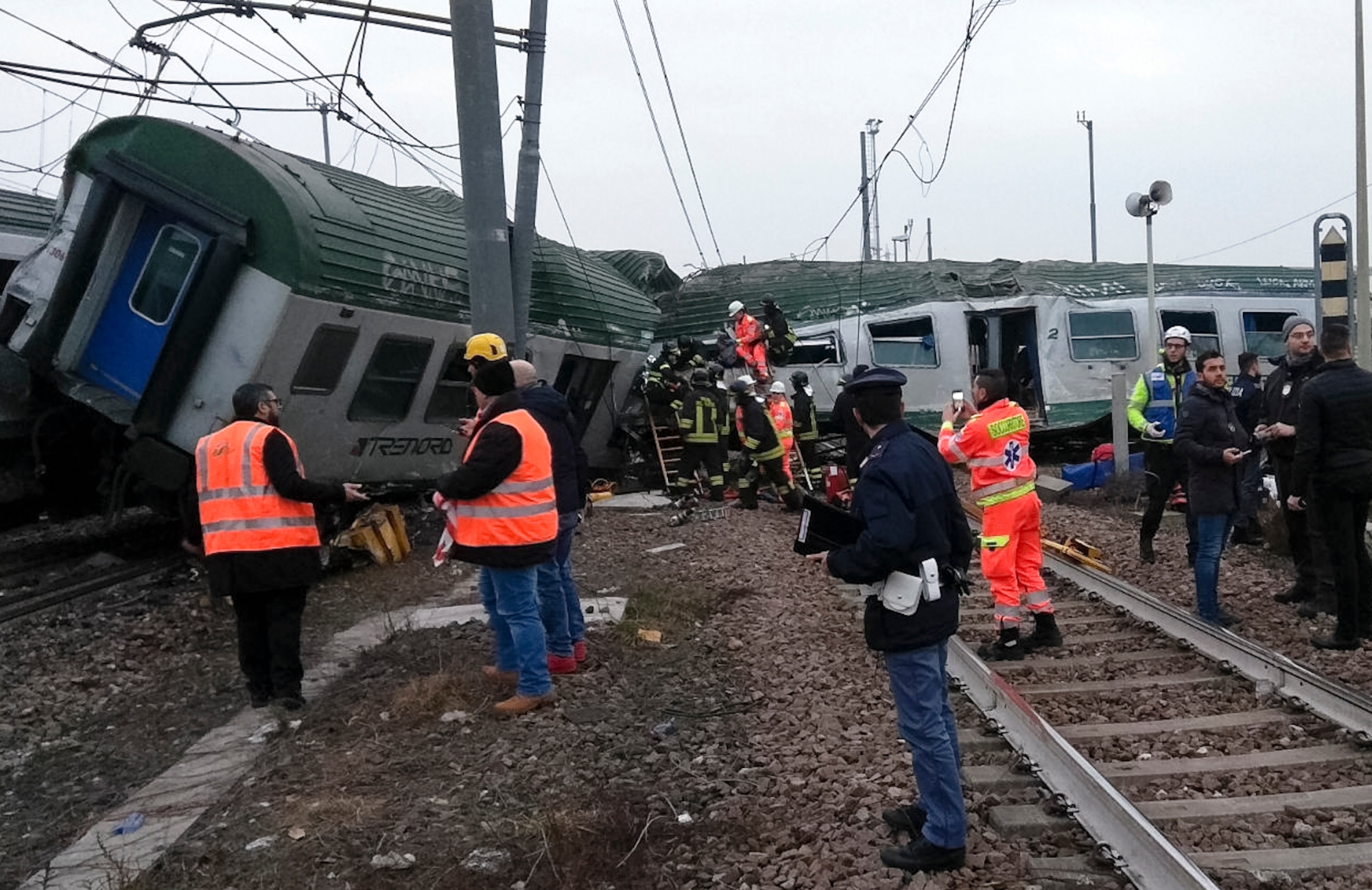 Rescuers work at the wrecked car of a train that derailed at the station of Pioltello Limito, on the outskirts of Milan, Italy, Thursday, Jan. 25, 2018. Italian officials said that the commuter train derailed in northern Italy, killing some people, seriously injuring 10 and trapping others heading into Milan at the start of the work day. (AP Photo) Italy Train Derailment