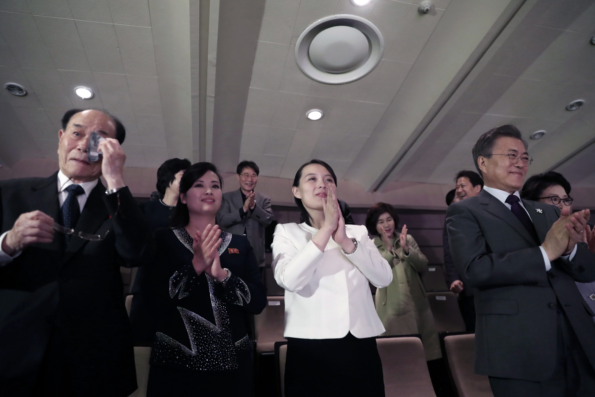 North Korea's nominal head of state Kim Yong Nam, left, wipes his tears as South Koran President Moon Jae-in, right, Kim Yo Jong, North Korean leader Kim Jong Un's sister, and Hyon Song Wol, second from left, leader of North Korea's Samjiyon Orchestra, applaud after a performance of North Korea's Samjiyon Orchestra at National Theater in Seoul, South Korea, Sunday, Feb. 11, 2018. A rare invitation to Pyongyang for South Korea's president marked Day Two of the North Korean Kim dynasty's southern road tour, part of an accelerating diplomatic thaw that included some Korean liquor over lunch and the shared joy of watching a "unified" Korea team play hockey at the Olympics. (Bee Jae-man/Yonhap via AP) South Korea Koreas Olympics