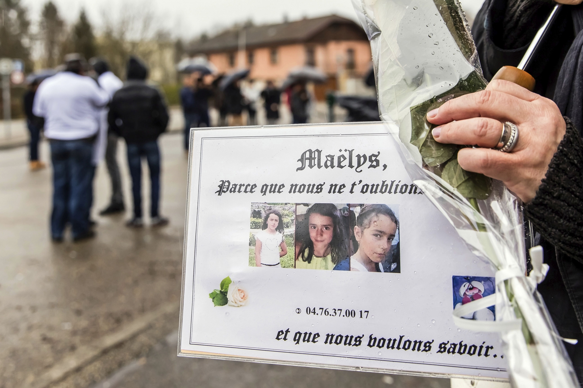 In this picture dated Wednesday, Dec. 27, 2017, people take part in a "white march" in tribute to missing girl, Maelys de Araujo, in Pont-de-Beauvoisin, central France. French authorities have handed preliminary kidnapping charges to a 34-year-old man in the case of a 9-year-old girl who went missing four months ago from a wedding celebration in France. (AP Photo/Darius) FRANCE MISSING GIRL