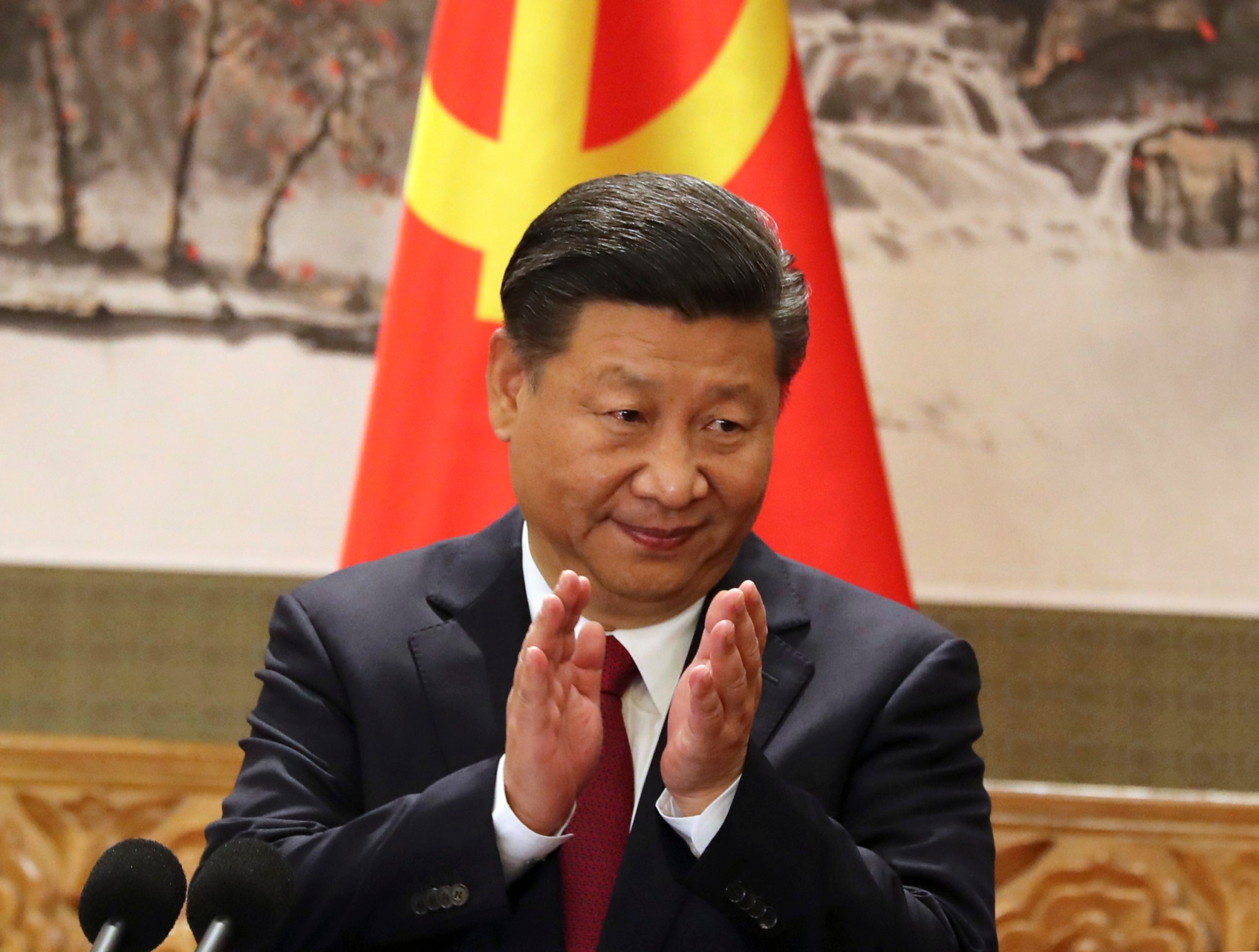 FILE - In this Oct 25, 2017, file photo, Chinese President Xi Jinping claps while addressing the media as he introduces new members of the Politburo Standing Committee at Beijing's Great Hall of the People. On a proposal made public Sunday, Feb. 25, 2018, China's ruling Communist Party proposes removing a limit of two consecutive terms for the president and vice president. (AP Photo/Ng Han Guan, File) China Politics