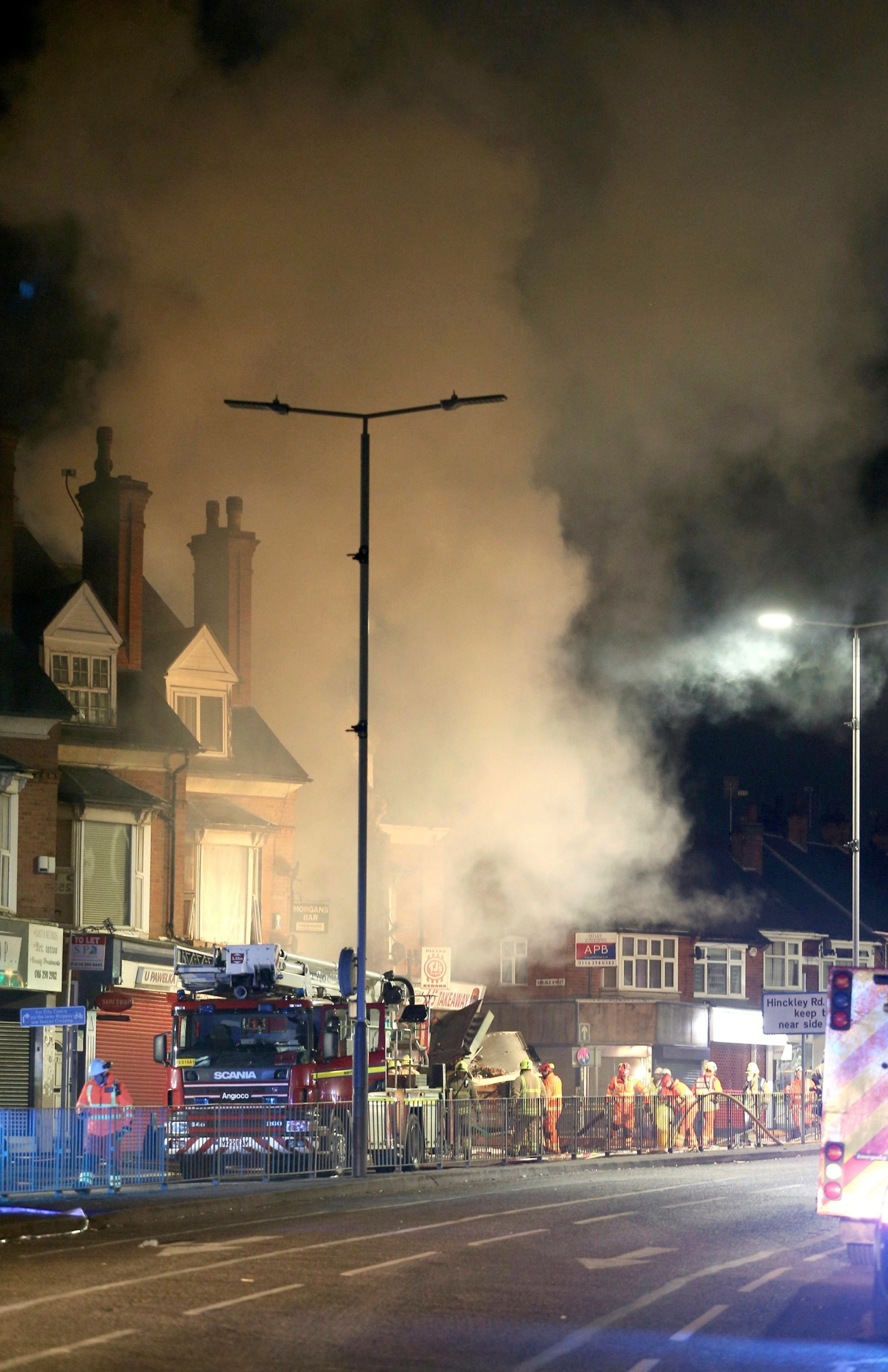 Emergency personnel attend the scene of an incident in Leicester, central England, Sunday Feb. 25, 2018. Four people were hospitalized in critical condition following an explosion that left a building in the English city of Leicester in flames Sunday, local emergency agencies said. (Aaron Chown/PA via AP) Britain City Explosion